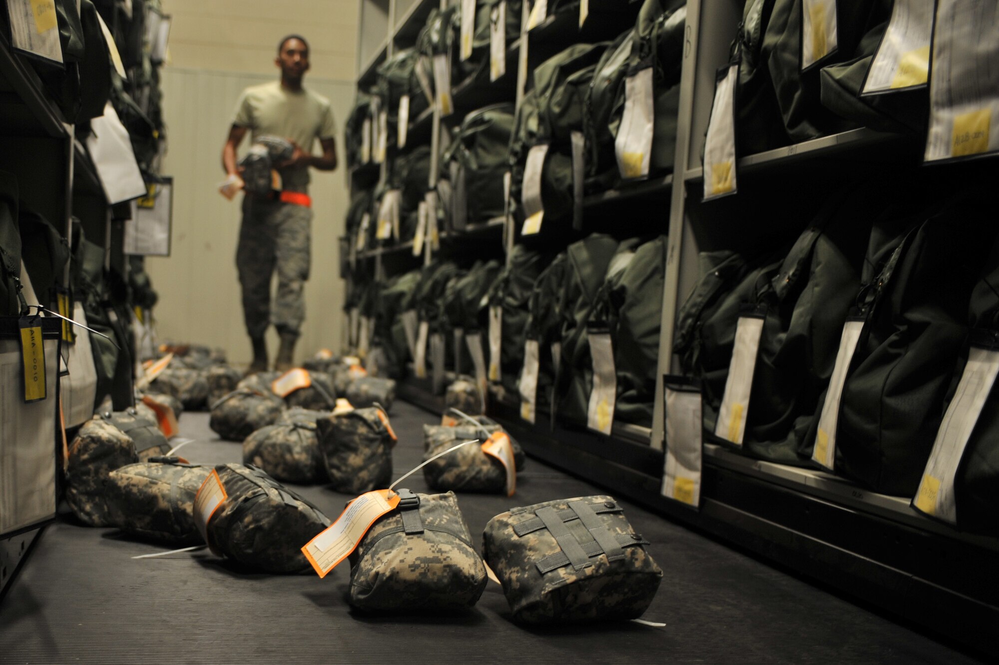 U.S. Air Force Airman 1st Class Ryan Williams, 27th Special Operations Logistics Readiness Squadron material management flight, collects expired individual first aid kits that were removed from several mobility bags at Cannon Air Force Base, N.M., July 17, 2012. The material management flight stocks and issues 26,000 line items of supplies and equipment, including mobility bags and weapons. (U.S. Air Force photo/Airman 1st Class Eboni Reece)