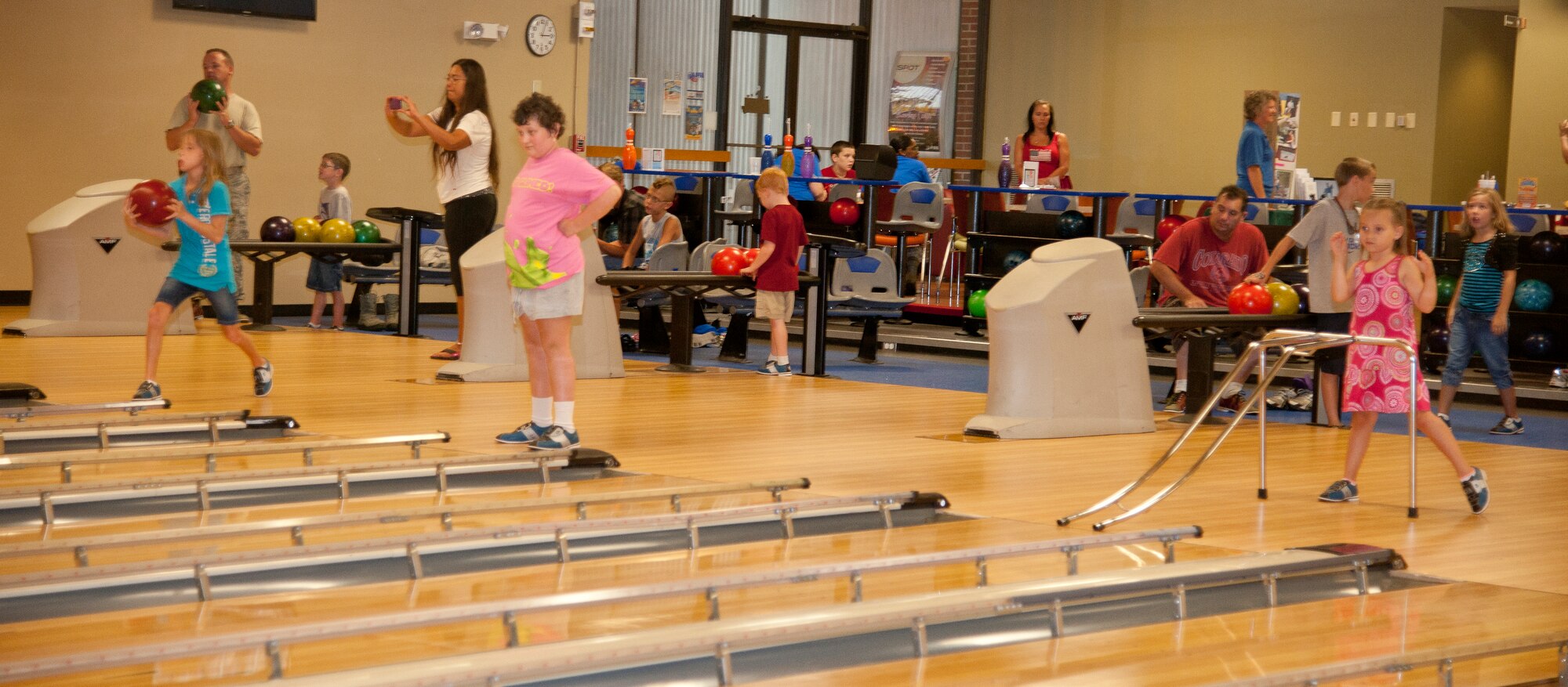 Moody family members bowl at The Spot during an Exceptional Family Members Program event at Moody Air Force Base, Ga., July 17, 2012. Families brought their children to bowl, eat, play and get their faces painted while also gathering information about services offered by the EFMP. (Airman 1st Class Paul Francis/Released)
