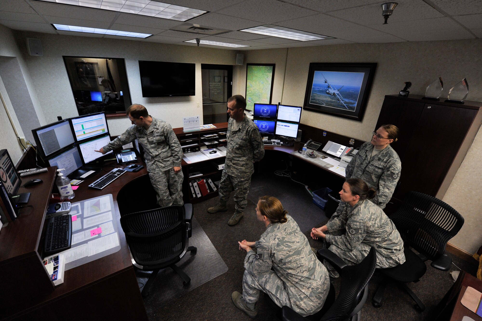 Members of the 19th Operations Support Squadron weather flight talk about meteorology July 11, 2012, at Little Rock Air Force Base, Ark. During the conversation the weather flight discussed weather threat assessment and the weather forecast for the next 30 hours. (U.S. Air Force photo by Airman 1st Class Rusty Frank)