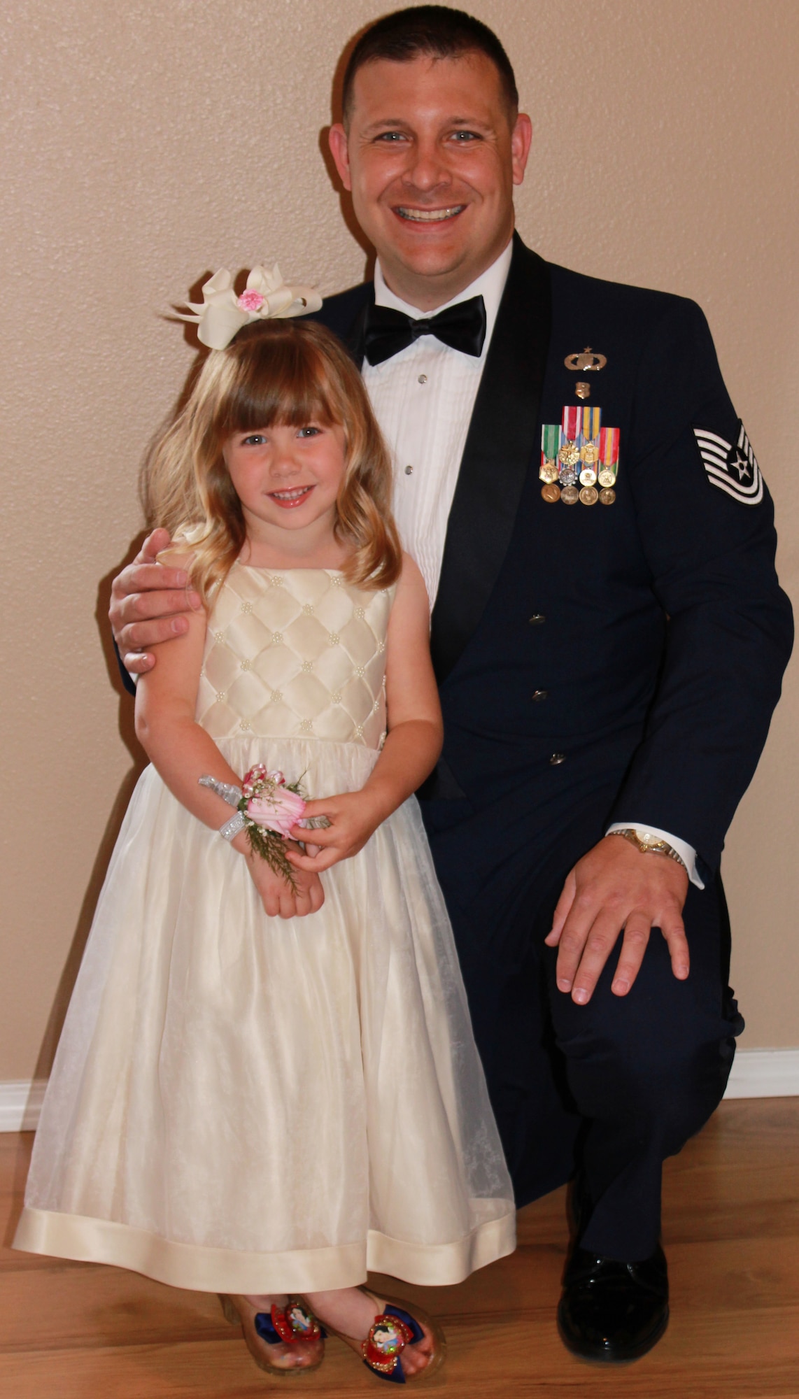 Tech. Sgt. Christopher Varner, 354th Fighter Wing NCO in-charge of chapel operations, and his daughter Grace, 4, pose for a photo at the Annual Father Daughter Dance at the Carlson Center July 7, 2012, Fairbanks, Alaska. Varner took the opportunity to show Grace what a special person she is to him and share special memories that could last a lifetime. (Courtesy photo)