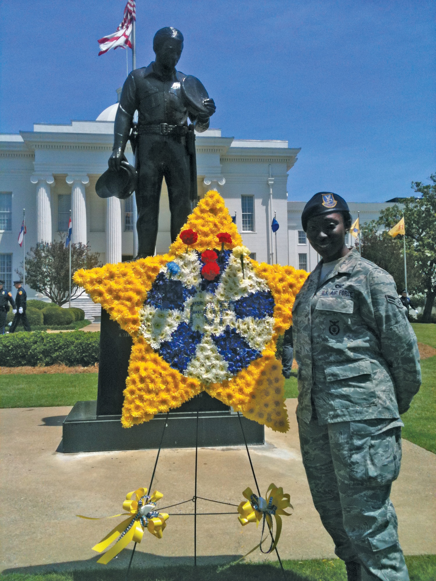 The State of Alabama held a memorial in honor of those who sacrificed their lives to protect the public May 11, 2012, at the state capitol. Representing the military from local Maxwell Air Force Base, security forces troop Airman 1st Class Faren Douglas stands at by a flower star at a memorial service hosted by Fraternal Order of Police at the Alabama state capitol. (US Air Force photos/Tech. Sgt. William Powell)
