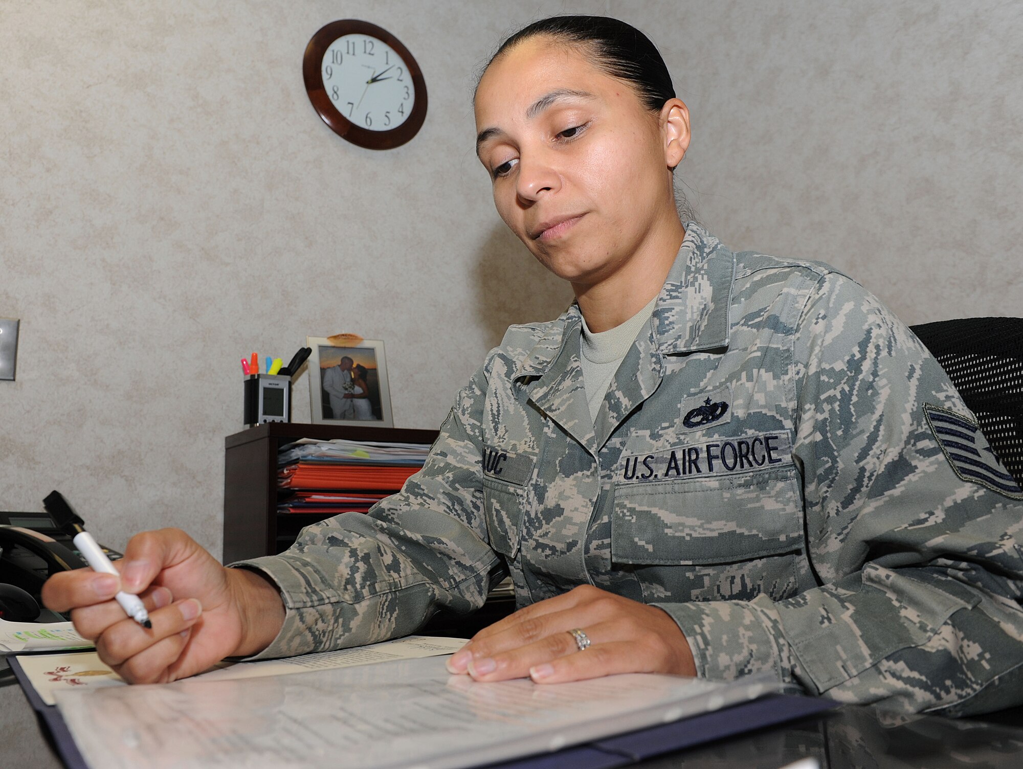 Tech Sgt. Brenda Taluc, a 19th Maintenance Group technical administrator, goes through a decoration checklist July 17, 2012, at Little Rock Air Force Base, Ark. Taluc goes through approximately 20 awards and taskers a week. (U.S. Air Force photo by Airman 1st Class Ellora Remington)
