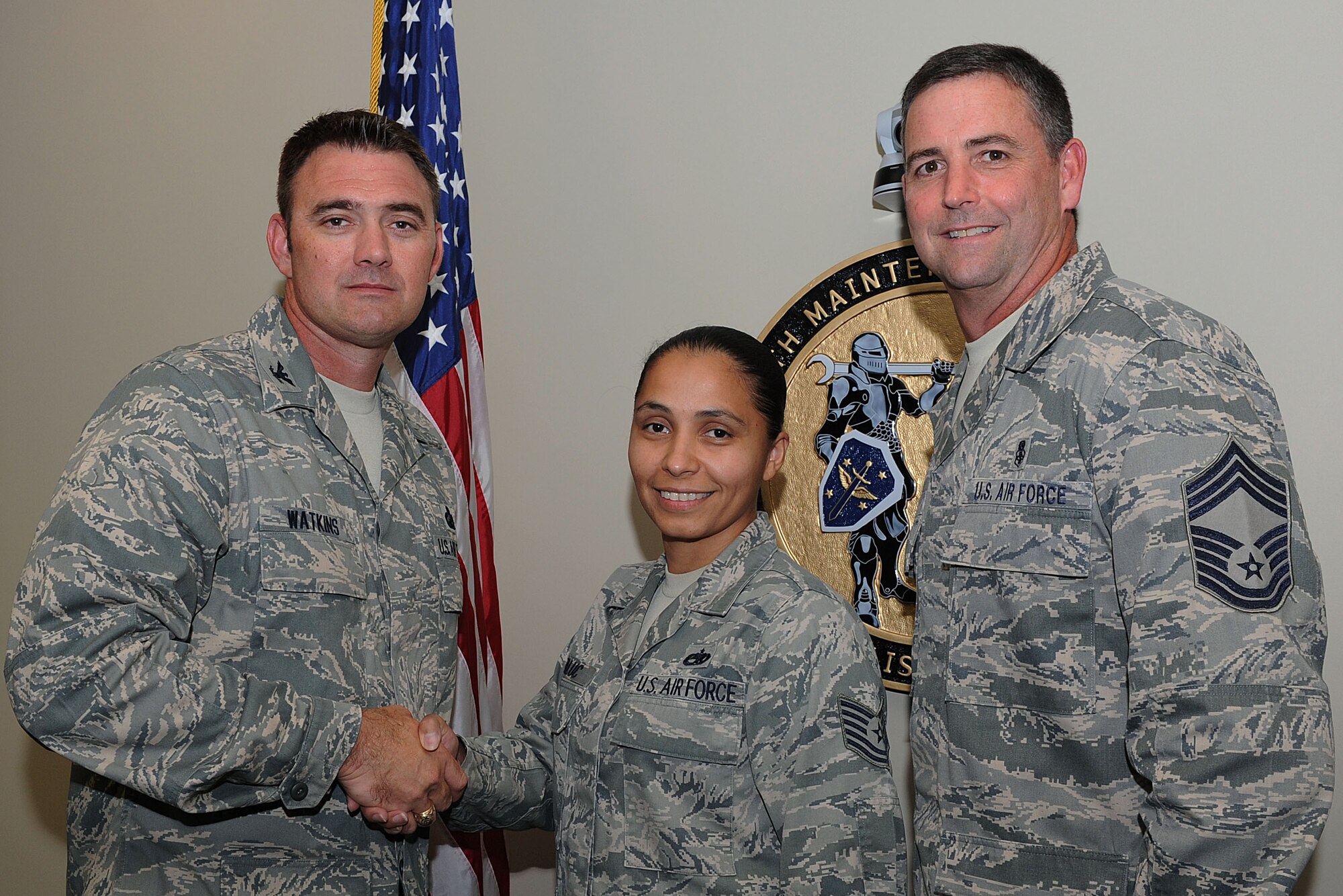 Col. Tracey Watkins, 19th Airlift Wing acting vice commander, and Chief Master Sgt. Gregory McNeil, 19th Medical Group superintendent, congratulate Tech Sgt. Brenda Taluc, a 19th Maintenance Group technical administrator, on her selection as Combat Airlifter of the Week July 17, at Little Rock Air Force Base, Ark. Taluc, a San Antonio, Texas, native, is responsible for tracking Group and Wing administrator suspenses. (U.S. Air Force photo by Airman 1st Class Ellora Remington)