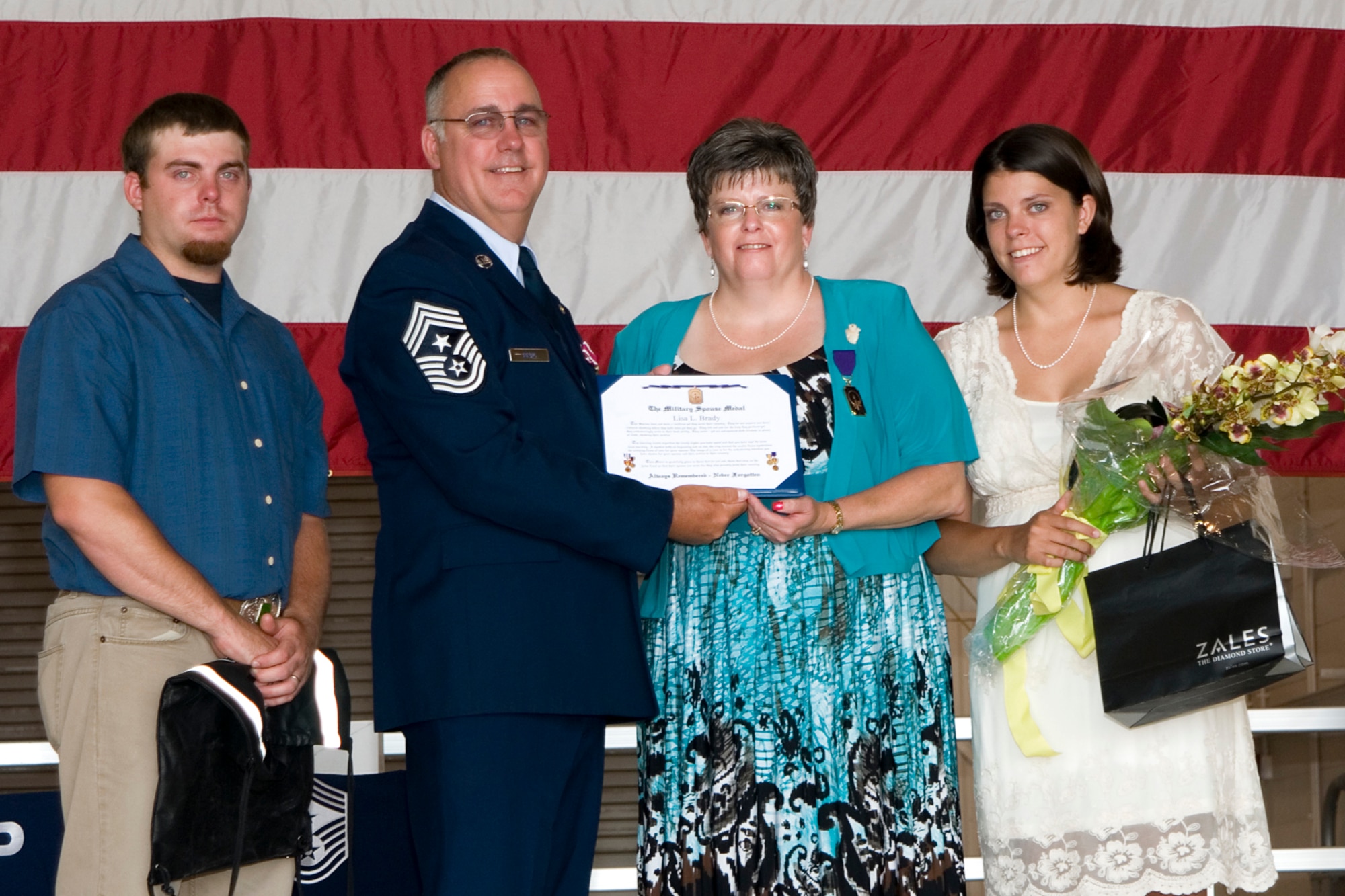GRISSOM AIR RESERVE BASE, Ind. -- Chief Master Sgt. Larry Brady, former 434th Air Refueling Wing command chief, presents a Military Spouse Medal to his wife, Lisa, during his retirement ceremony at Grissom July 8. Brady retired after 28 years of service. (U.S. Air Force photo/Senior Airman Andrew McLaughlin)