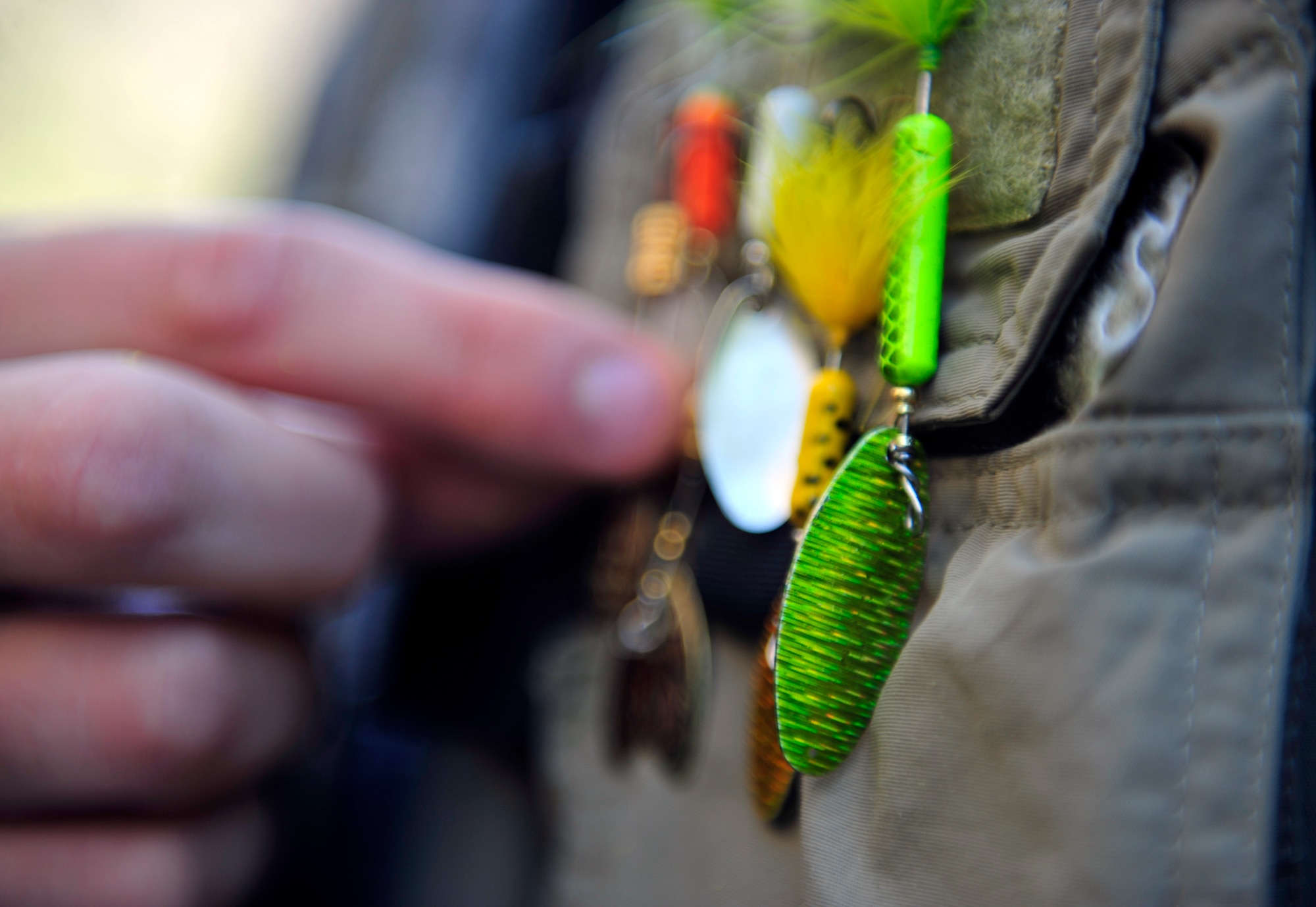 CLEAR CREEK, Colo. – Christopher Gross, 460th Space Wing Public Affairs, detaches a lure off of his fishing vest while fishing at Clear Creek July 10,2012. The Creek is home to Browns, Brooke, Rainbow and Cutthroat trout. (U.S. Air Force photo/Senior Airman Paul Labbe.)