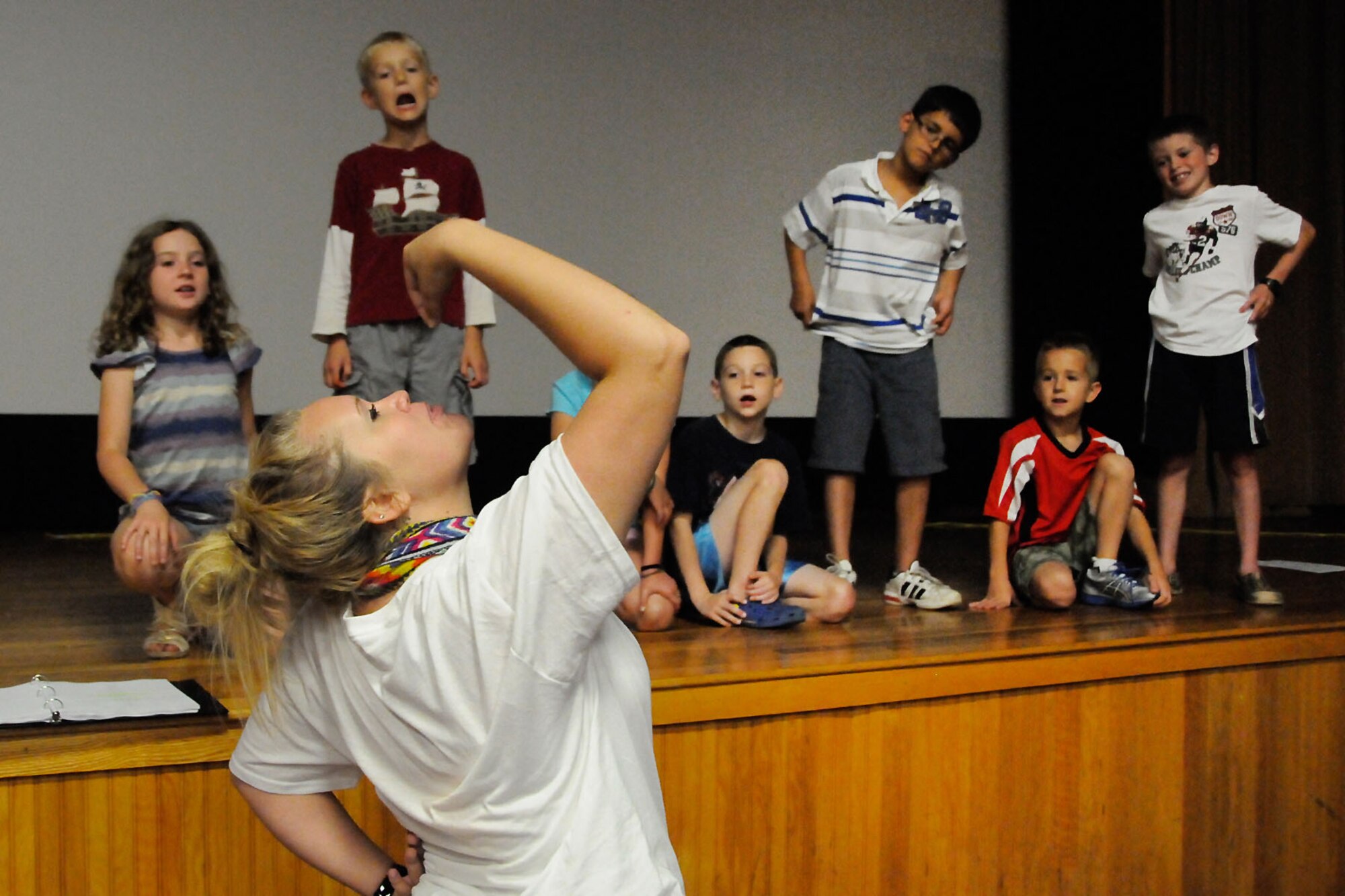 HANSCOM AIR FORCE BASE, Mass. – Children watch as Britt Hensley acts out a scene during rehearsal for the Missoula Children’s Theater production of Hansel and Gretel. After only a week of practice, Hanscom youth will perform the play at the base theater July 21 at 10 a.m. and 2 p.m. for free. (U.S. Air Force photo by Linda LaBonte Britt)