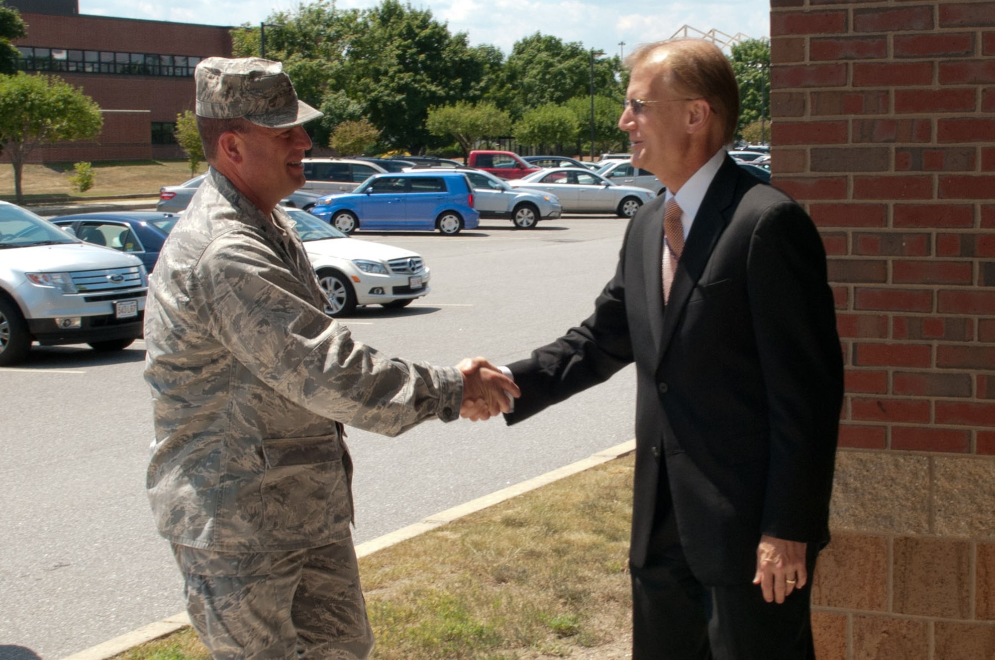 HANSCOM AIR FORCE BASE, Mass. – Brig. Gen. Dwyer Dennis, Intelligence, Surveillance, Reconnaissance and Requirements director, greets Steven Wert, Battle Management program executive officer, during his visit here July 12. Dennis visited Hanscom to receive updates on several mission areas. He previously served as commander of the 551st Electronic Systems Wing from June 2007 to September 2009, a precursor organization to the Battle Management Directorate (U.S. Air Force photo by Rick Berry) 