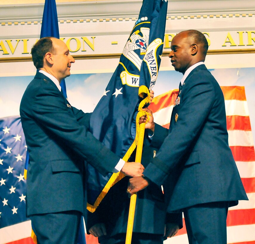 Brig. Gen. Cedric D. George, right, accepts command of the Warner Robins Air Logistic Complex from Lt. Gen. Bruce A. Litchfield, commander of the Air Force Sustainment Center July 17.  (U. S. Air Force photo/Sue Sapp)