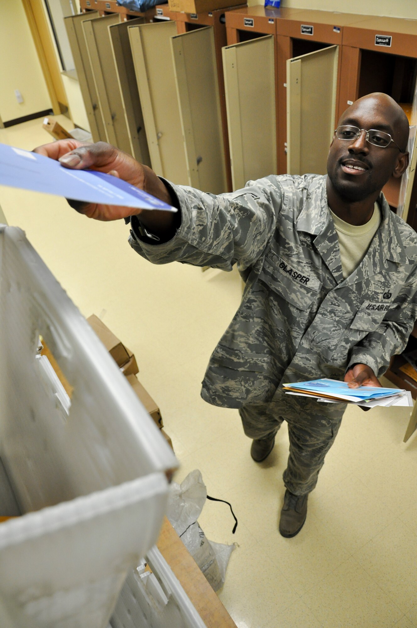 BUCLKEY AIR FORCE BASE, Colo. – Staff Sgt. Loywless Glasper, Buckley’s Official Mail Center organization mail technician, separates mail into organizational containers.  The mail center provides service for these 99 consolidated organizations across the 22 on-base and one off-base mail stops it makes.  (U.S. Air Force photo by Staff Sgt. Nicholas Rau)