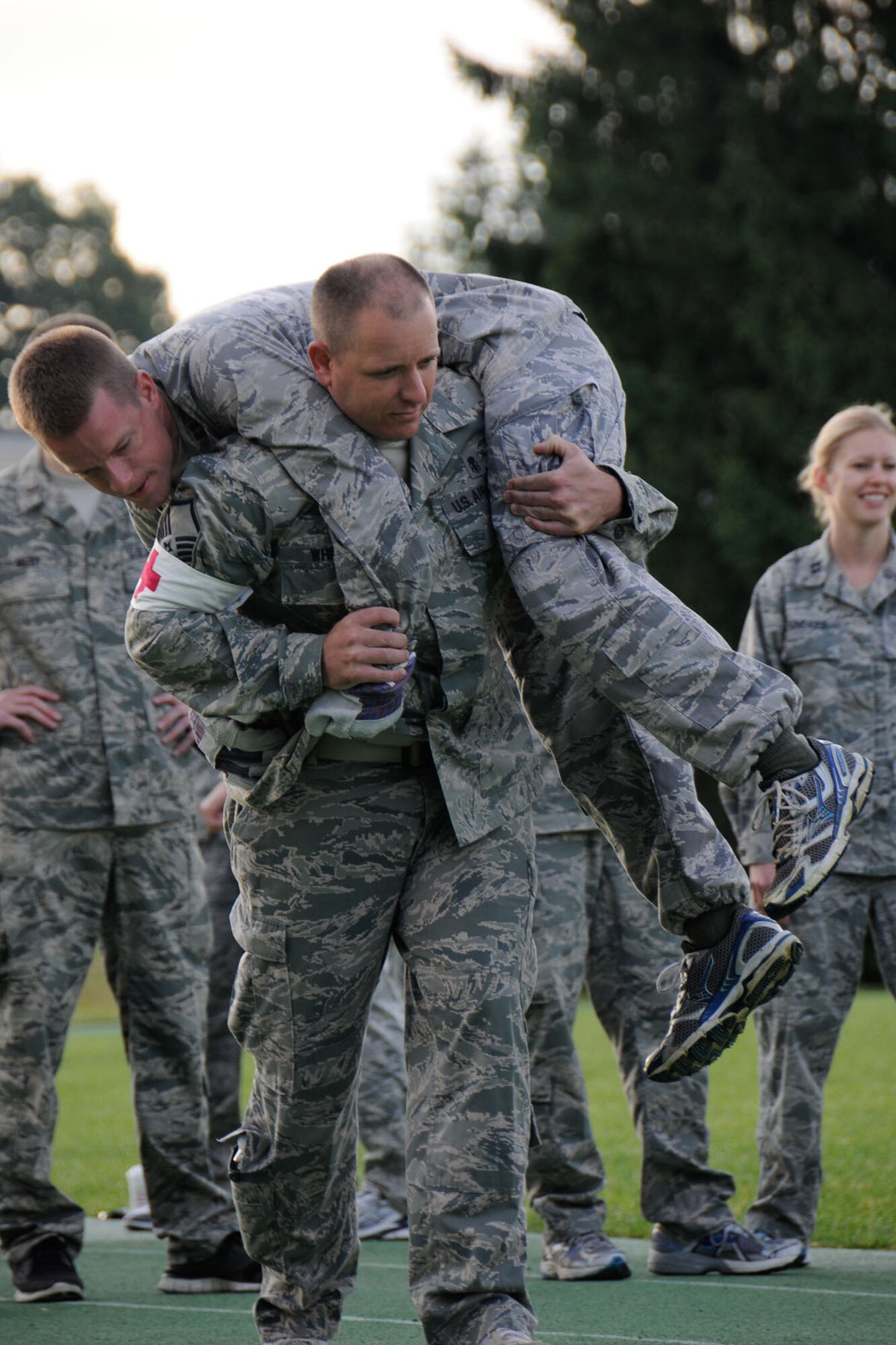HANSCOM AIR FORCE BASE, Mass. – Master Sgt. Brent Whitby carries Capt. Joshua Elston on the track during Warrior Day July 11. The Warrior Day course was composed of seven different stations that included physical challenges, a written test and problem solving activities. (U.S. Air Force photo by Linda LaBonte Britt)