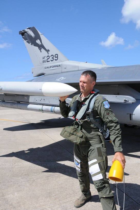 Capt. Matt Eslow of the 194th Fighter Squadron, 144th Fighter Wing, performs a pre-flight inspection on a F-16 fighter jet during RIMPAC 2012.The 2012 Rim of the Pacific exercise is the twenty-third maneuver in a history of bi-annual drills that dates back four decades. The purpose of the exercise is to bring together nations to observe, train and exchange information that fosters a cooperative training environment.  (Air National Guard photograph by MSgt. David J. Loeffler)