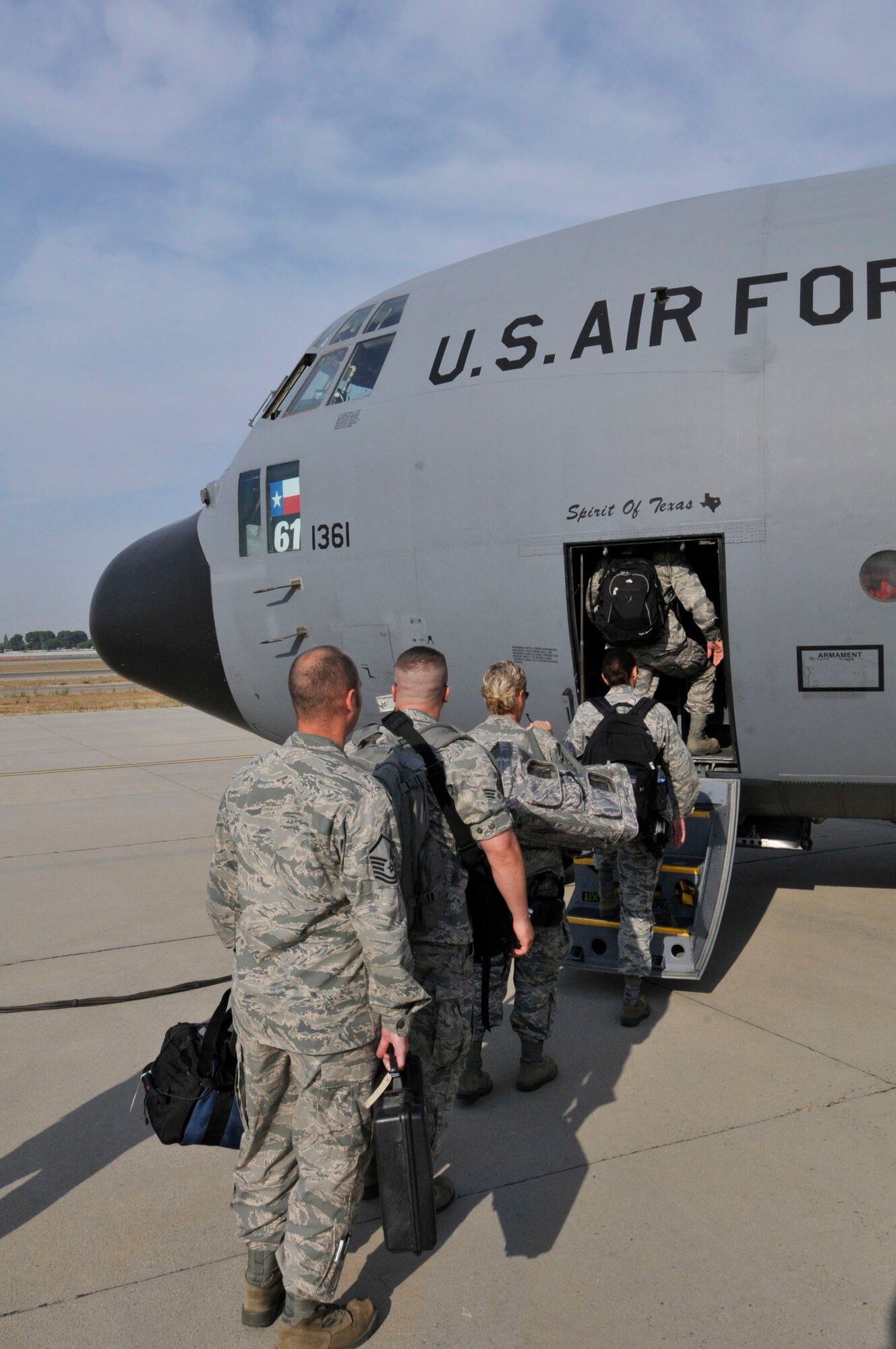 Airmen from the 144th Fighter Wing, California Air National Guard, board a C-130 cargo plane from the 136th Airlift Wing from Texas on July 13, 2012.  The Airmen are on their way to Joint Base Pearl Harbor-Hickam in support of the Rim of the Pacific (RIMPAC) exercise.  The 2012 RIMPAC exercise is the twenty-third maneuver in a history of bi-annual drills that dates back four decades. The purpose of the exercise is to bring together nations to observe, train and exchange information that fosters a cooperative training environment. (Air National Guard photograph by Senior Master Sgt. Chris Drudge)