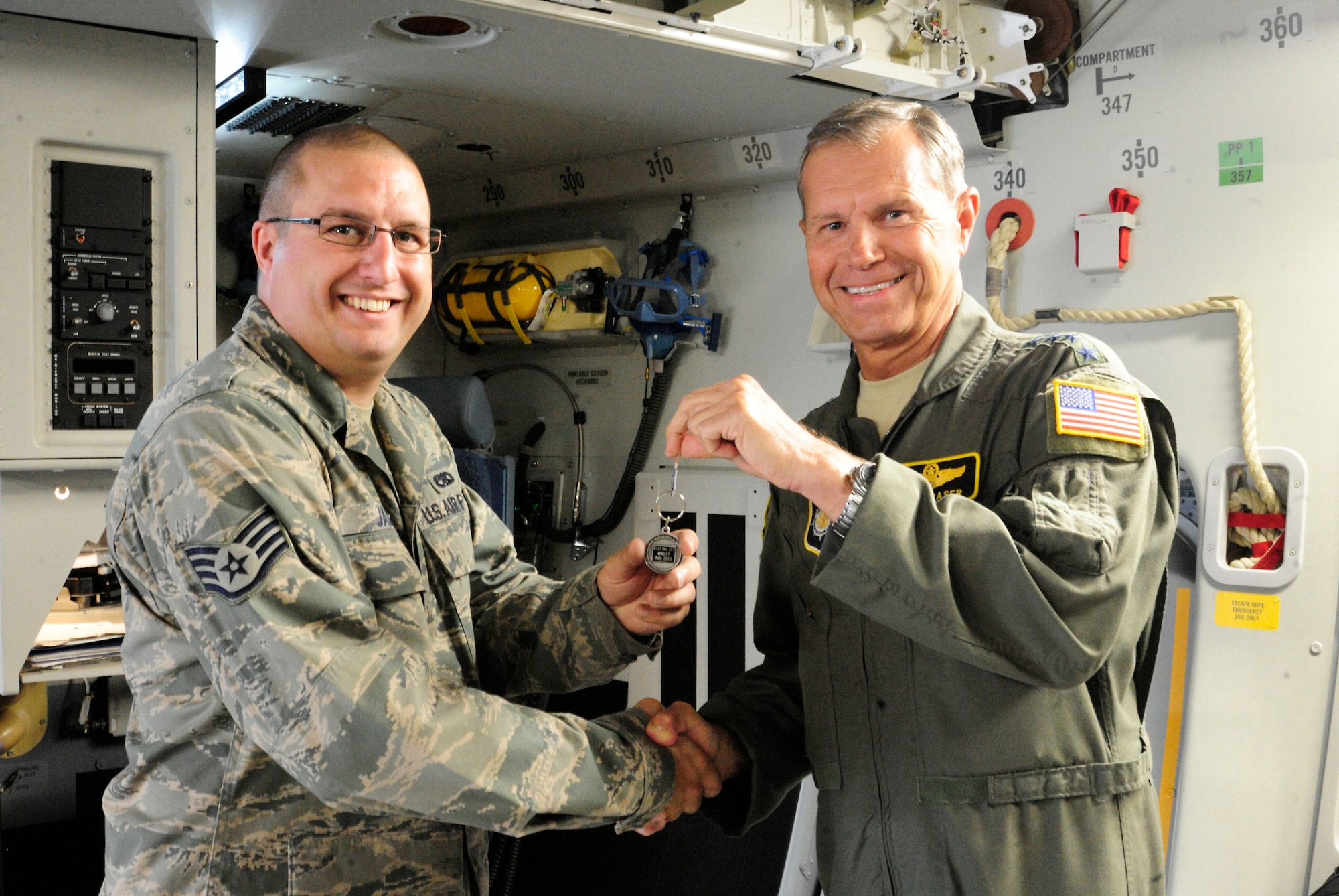 Staff Sgt. Joshua Jaburek, 62nd Aircraft Maintenance Squadron, receives the key to McChord Field’s newest C-17 Globemaster III from Gen. William M. Fraser III, U.S. Transportation Command commander, July 17, 2012, at Joint Base Lewis-McChord, Wash. (U.S. Air Force photo/ Adamarie Lewis-Page)