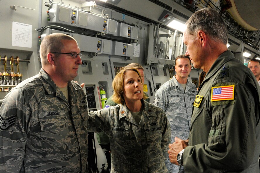 Maj. Emily Farkas, 62nd Aircraft Maintenance Squadron commander (center), introduces Staff Sgt. Joshua Jaburek, 62nd AMXS, to Gen. William M. Fraser III, U.S. Transportation Command commander, July 17, 2012, at Joint Base Lewis-McChord, Wash. Jaburek was chosen to receive the keys to McChord Field’s newest C-17. (U.S. Air Force photo/Adamarie Lewis-Page)