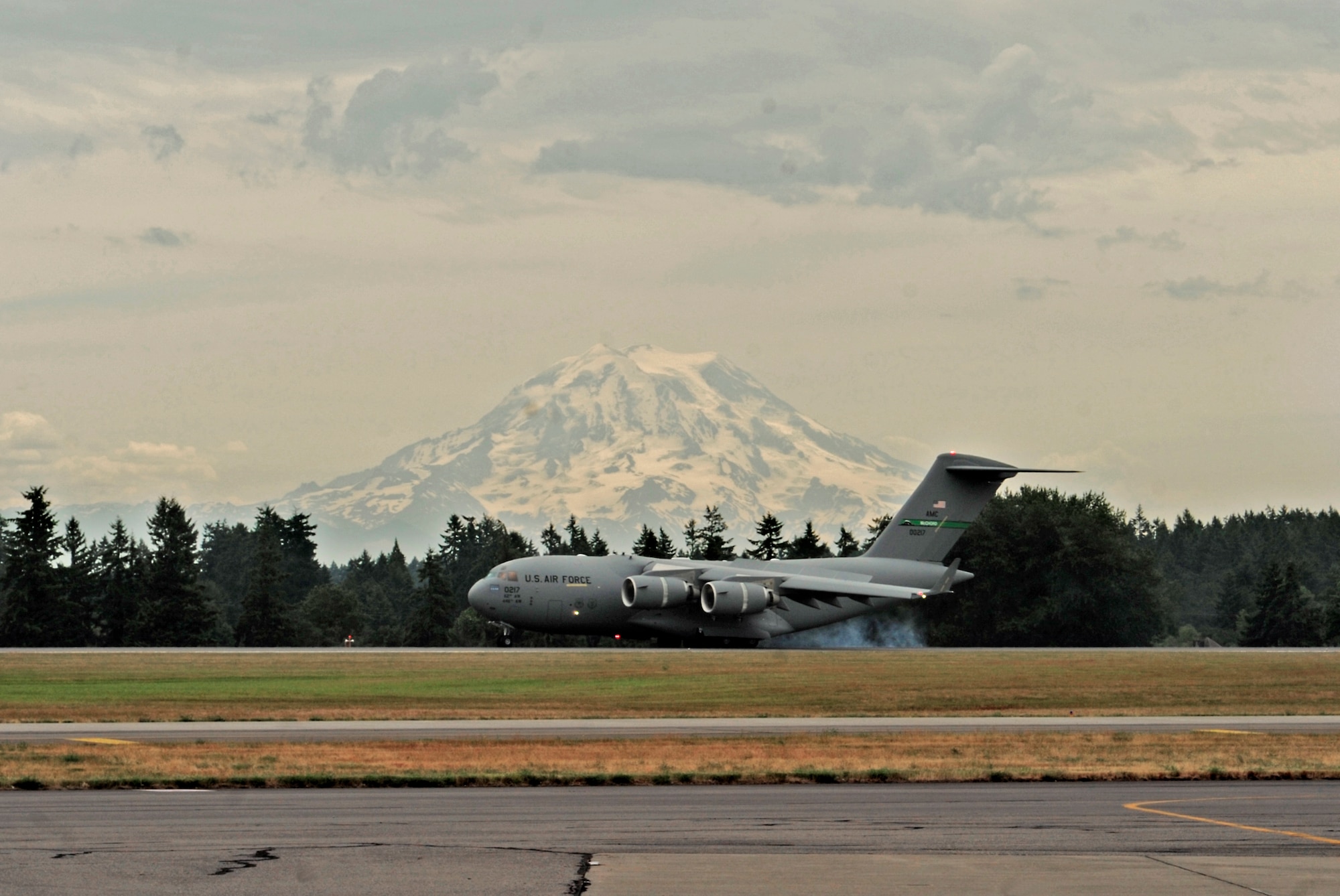 McChord Field's newest C-17 Globemaster III lands July 17, 2012, at Joint Base Lewis-McChord, Wash. On board was Gen. William M. Fraser III, U.S. Transportation Command commander, who delivered the C-17 from Long Beach, Calif. (U.S. Air Force photo/Adamarie Lewis-Page)