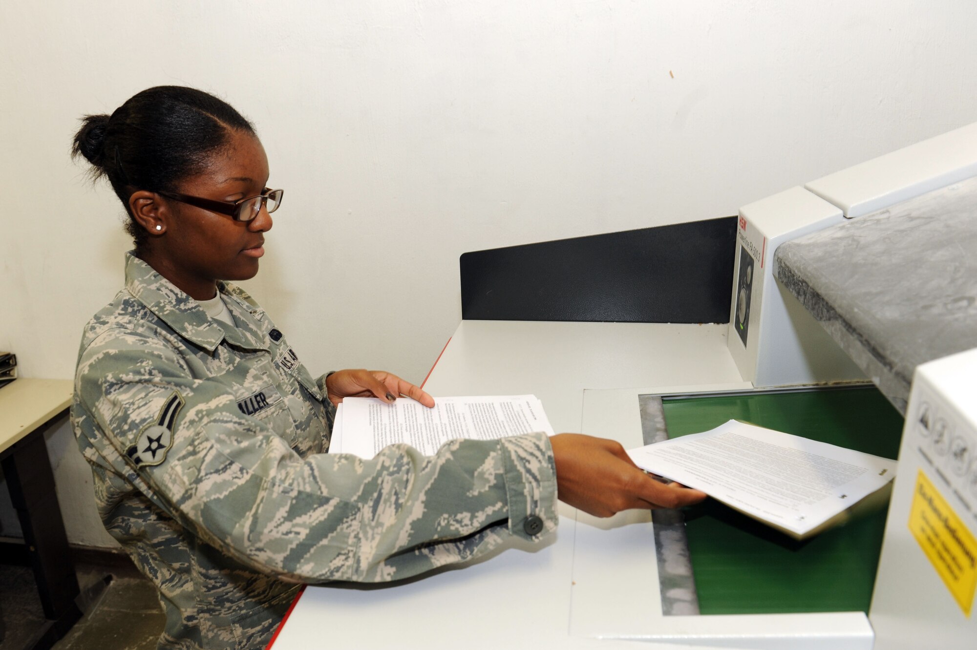 SPANGDAHLEM AIR BASE, Germany – Airman 1st Class Brittany Waller, 52nd Mission Support Group knowledge operations manager, shreds records here July 17. Records are shredded after they have reached their disposition date. The disposition date changes depending on what type of document is being accessed. Nine people work in the knowledge operations shop and oversee base records across multiple platforms ensuring critical base-level information is provided to leadership. (U.S. Air Force photo by Senior Airman Christopher Toon/Released)