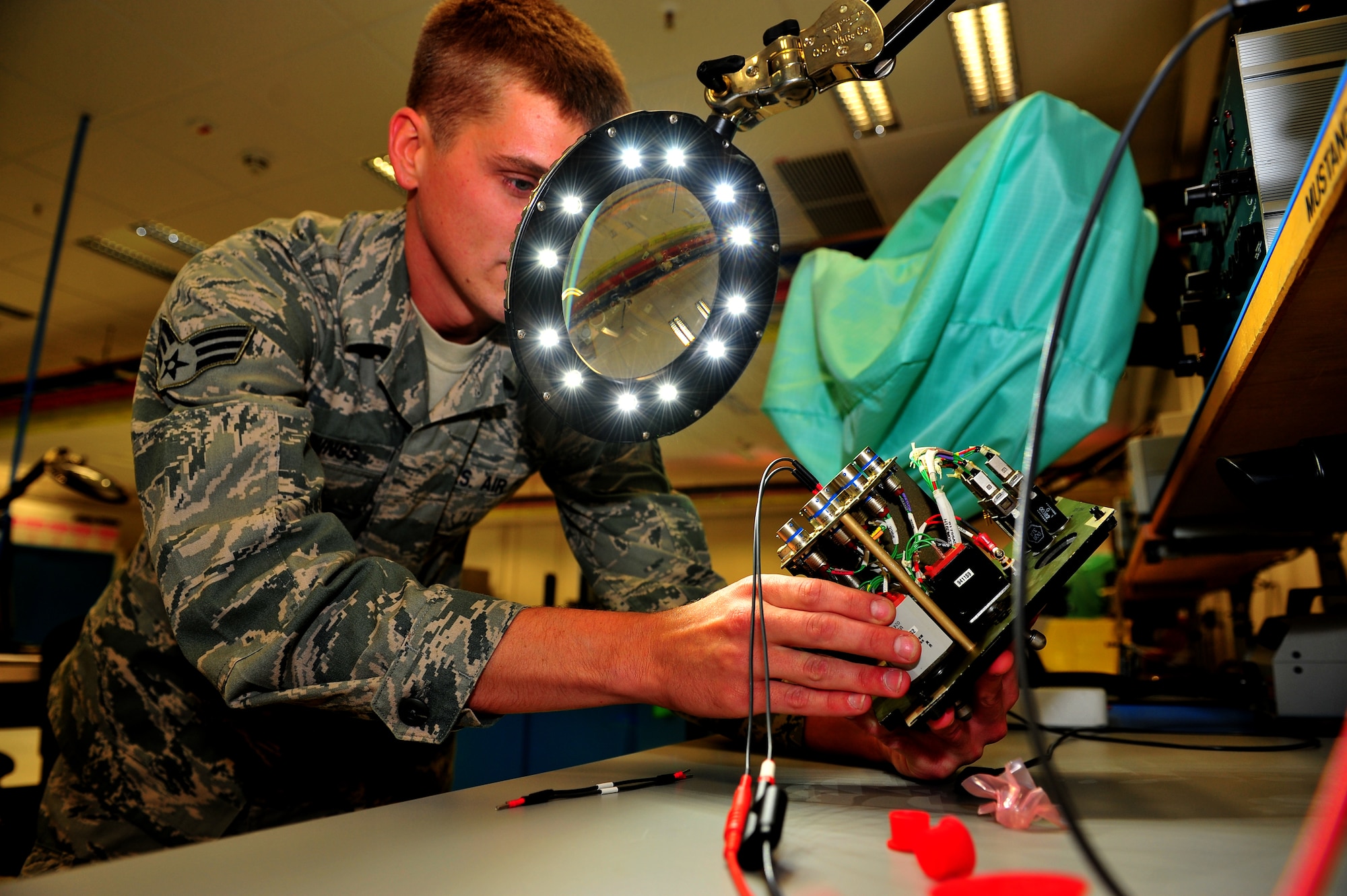 SPANGDAHLEM AIR BASE, Germany – Senior Airman Andrew Jennings, 52nd Component Maintenance Squadron avionics system technician and Air Force repairs enhancement program secondary technician, performs a functions check on the circuits of a landing gear panel inside the 52nd Maintenance Group AFREP section here July 17. The AFREP section fixes items that cannot be contracted out for repair and items that are cheaper to repair than replace. The majority of the services provided by the shop is for the 52nd Maintenance Group, but they can also help other groups within the 52nd Fighter Wing. The section saved more than $1 million last year for the Air Force while maintaining a credible combat power. (U.S. Air Force photo by Airman 1st Class Dillon Davis/Released)