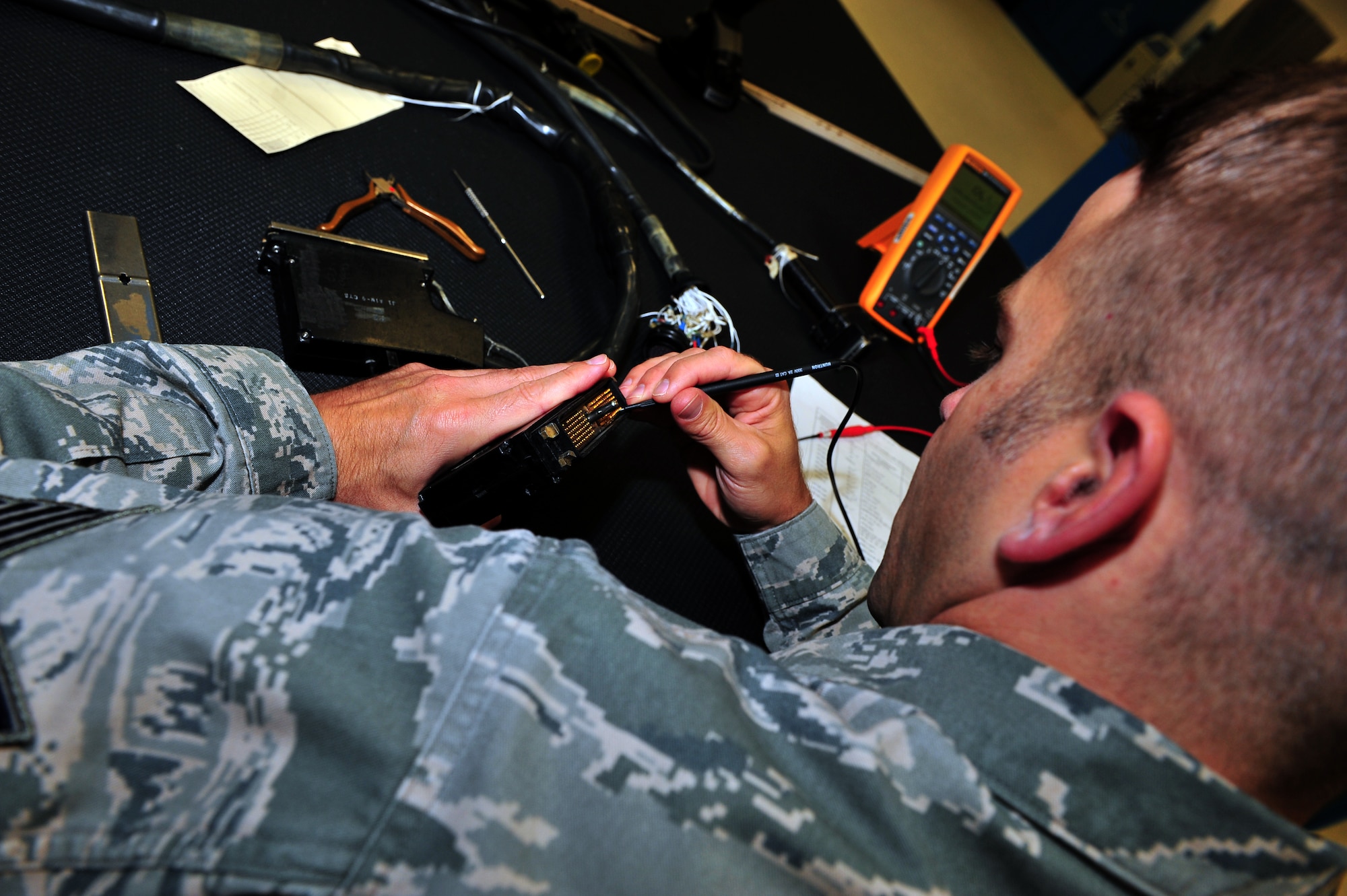 SPANGDAHLEM AIR BASE, Germany – Tech. Sgt. Robert Fuss, 52nd Maintenance Group Air Force repair enhancement program manager, performs a functions check on a circuit of an armament test station harness inside the 52nd MXG AFREP section here July 17. The AFREP section fixes items that cannot be contracted out for repair and items that are cheaper to repair than replace. The majority of the services provided by the shop is for the 52nd Maintenance Group, but they can also help other groups within the 52nd Fighter Wing. The section saved more than $1 million last year for the Air Force while maintaining a credible combat power. (U.S. Air Force photo by Airman 1st Class Dillon Davis/Released)