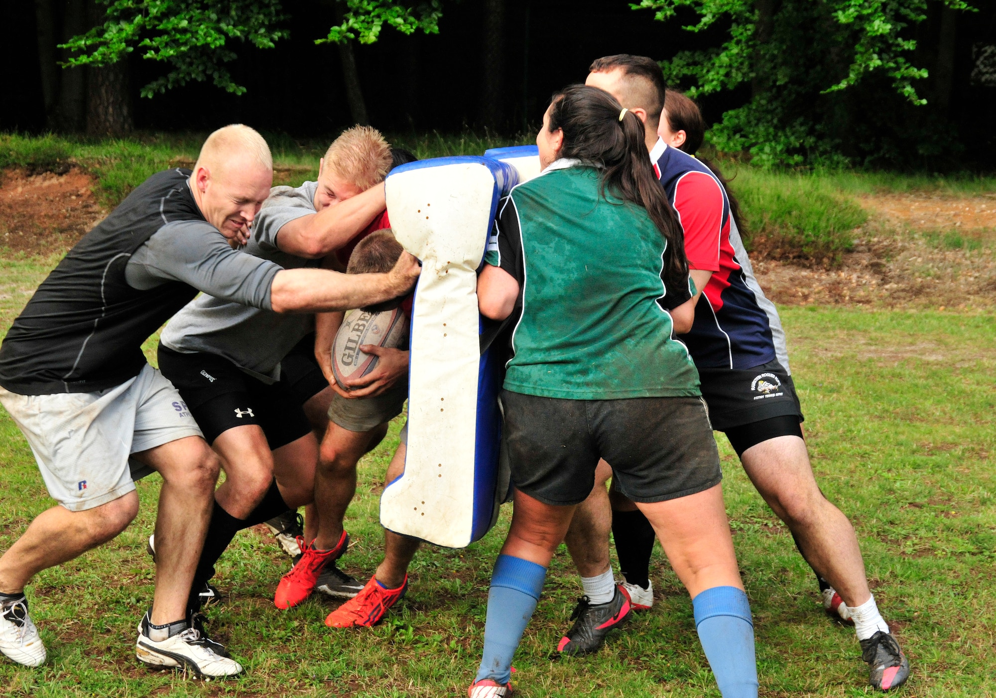 Members of the Ramstein Rogues collide during a ruck drill during a preseason practice at the 435th Construction Training Squadron rugby pitch at Ramstein Air Base, Germany, July 12, 2012. The Rogues have two men's teams and one women's team consisting of Host Nation players, British Royal Air Force and U.S. military Soldiers, Airmen from the Kaiserslautern area and dependents. (U.S. Air Force photo/Airman 1st Class Trevor Rhynes)
