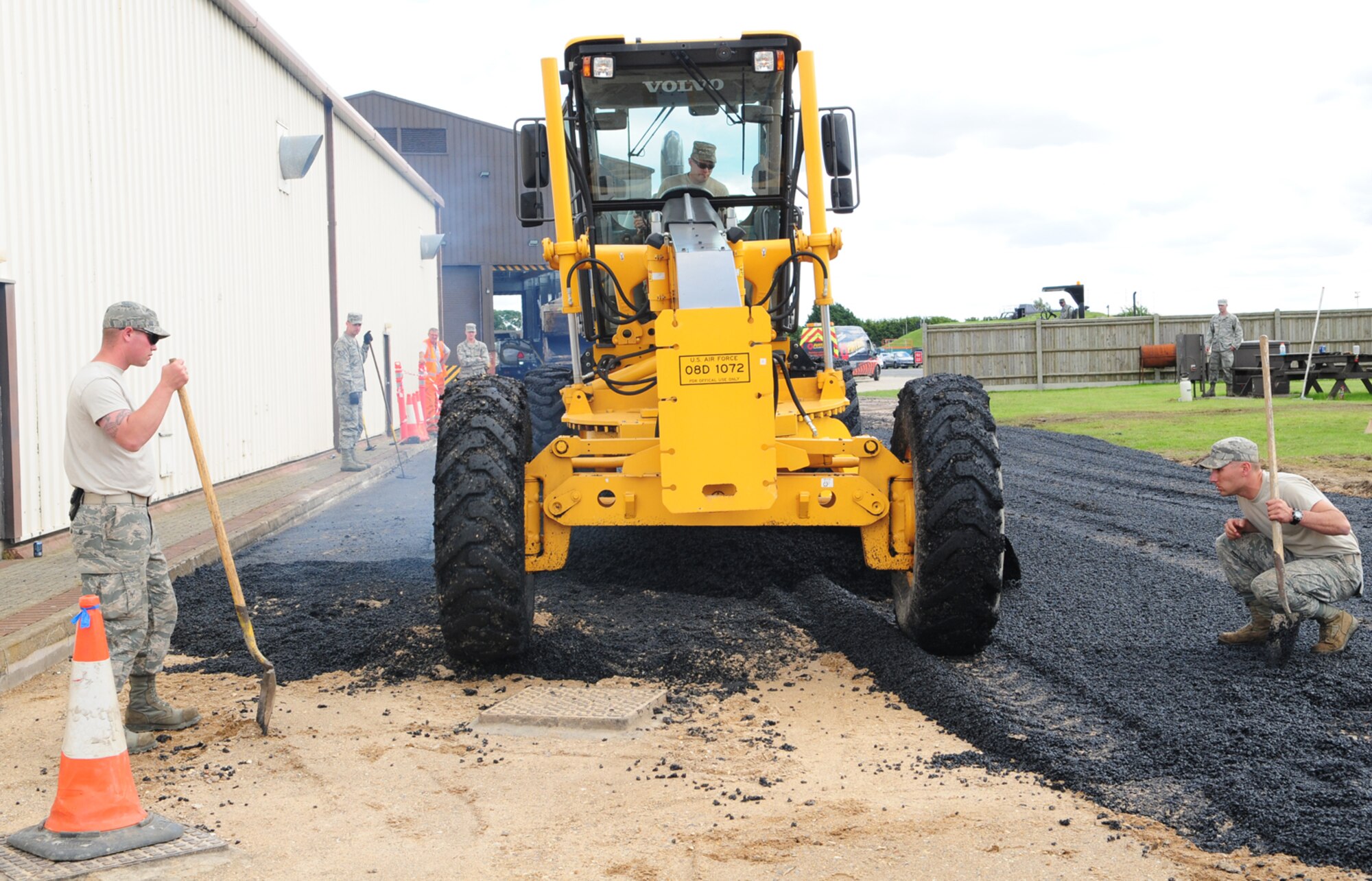 RAF MILDENHALL, England – Reservists from the 419th Civil Engineer Squadron, Hill Air Force Base, Utah, watch to ensure a grader is smoothing out fresh asphalt correctly July 12, 2012, at the 100th Logistics Readiness Squadron compound at RAF Mildenhall. The reservists were at RAF Mildenhall for two weeks, doing their annual training and working alongside 100th Civil Engineer Squadron members to assist in completing projects around base. (U.S. Air Force photo/Karen Abeyasekere)