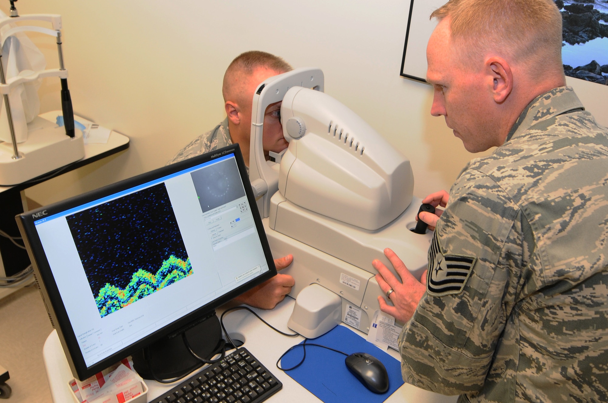 ANDERSEN AIR FORCE BASE, Guam – Tech. Sgt. Joshua Karash, 36th Medical Operations Squadron optometry technician, uses the optical coherence tomography to capture a picture of biological tissue within the eye of a patient July 18. This method provides a three-dimensional image of the eye to be analyzed.  (U.S. Air Force photo by Senior Airman Carlin Leslie/Released) 