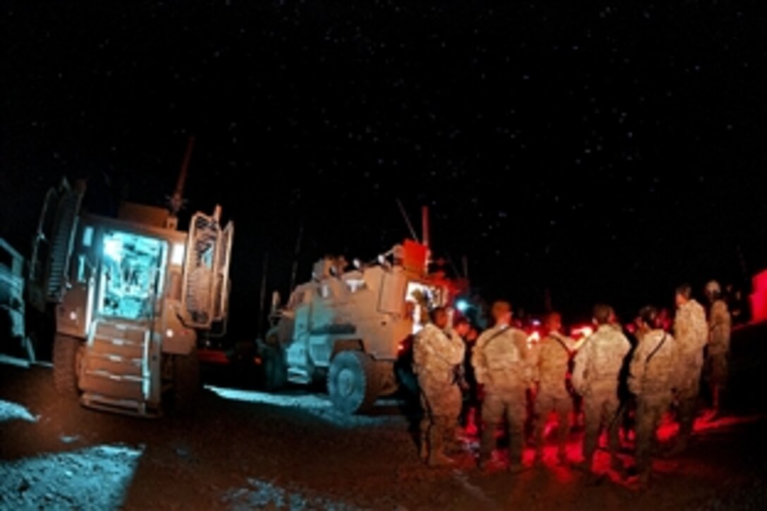 U.S. paratroopers gather for a mission brief before the return leg of a resupply convoy on Forward Operating Base Arian in Afghanistan's Ghazni province, July 9, 2012.