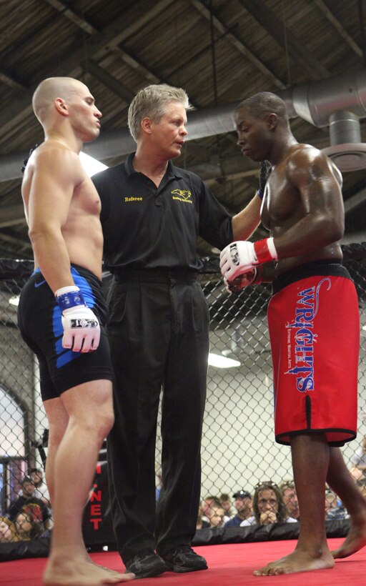 (Right) Sgt. David Lafayette with Wrights Extreme Martial Arts, steps up to his opponent Adam Miller during the Battle in the South IV hosted at the Coastline Convention Center in Wilmington, N.C. July 14. The event featured 12 bouts and two of them included devil dogs from Marine Corps Base Camp Lejeune.