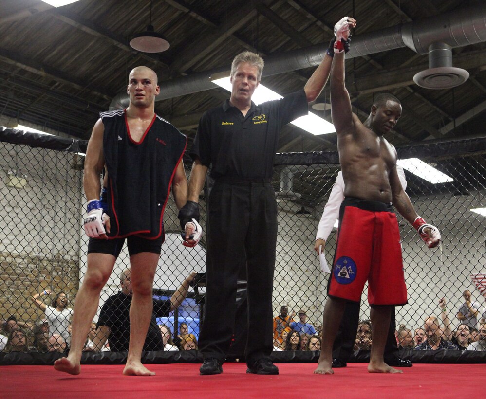 Sgt. David Lafayette (left) with Wrights Extreme Martial Arts, delivers a kick to his opponent Adam Miller during Battle in the South IV hosted at the Coastline Convention Center in Wilmington, N.C. July 14. The event featured 12 bouts and two of them included devil dogs from Marine Corps Base Camp Lejeune.