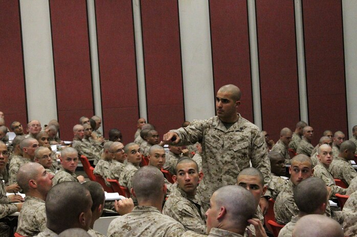 Sgt. Philip D. Krein, drill instructor, Instructional Training Company, Support Battalion teaches recruits from Company H, 2nd Recruit Training Battalion, how to stand duty aboard Marine Corps Recruit Depot San Diego July 17. Currently the recruits have limited hands on experience but Krein explained what recruits learn in boot camp is a foundation to grow upon.