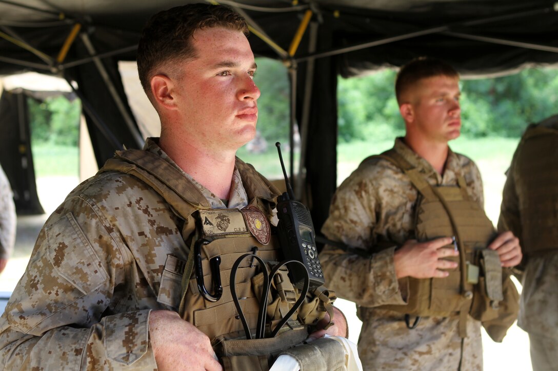 KIN BLUE TRAINING AREA, Okinawa, Japan - Lance Cpl. Colin J. Hoffman, a military policeman with Combat Logistics Battalion 31, 31st Marine Expeditionary Unit, awaits simulated refugees in the search area of an evacuation control center here, July 18. The training exercise heightens the Marines' readiness for non-combatant evacuation operations that may be required as a result natural disaster or violent insurrection. The 31st MEU is the United States' force in readiness for the Asia Pacific.