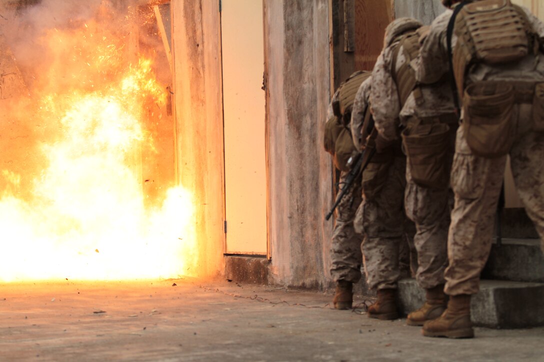 CAMP HANSEN, Okinawa, Japan - Assaultmen from Battalion Landing Team 2nd Battalion, 1st Marines, 31st marine Expeditionary Unit, detonate a door during urban mobility breaching training here, July 17. Assaultmen use their knowlege of demolitions to clear mine fields, breach doors and windows, and engage targets with the Mark 153 Shoulder-lounched Multipurpose Assault Weapon. The 31st MEU is the United States force in readiness for the Asia Pacific region.