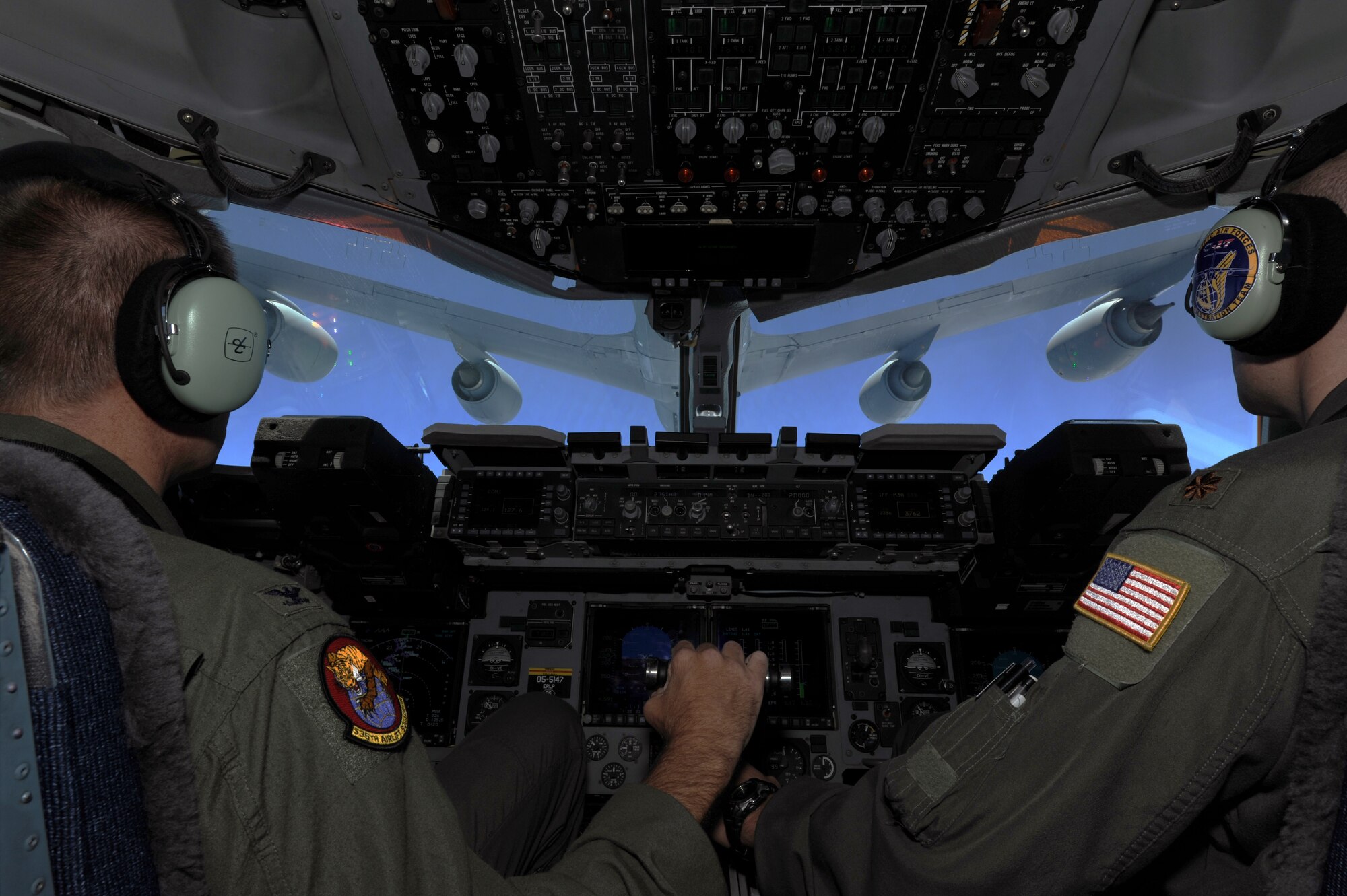 Col. Johnny Roscoe, 15th Wing commander (left), pilots a C-17 Globemaster III from the 535th Airlift Squadron at Joint Base Pearl Harbor-Hickam, Hawaii, with Maj. James Pasquino, 15th Wing executive officer, for an air-to-air refueling July 18 during Roscoe's first flight since taking command of the 15th Wing. The flight was part of the Rim of the Pacific military exercise; the largest naval exercise in the world. (U.S. Air Force photo by Capt. Ben Sakrisson)