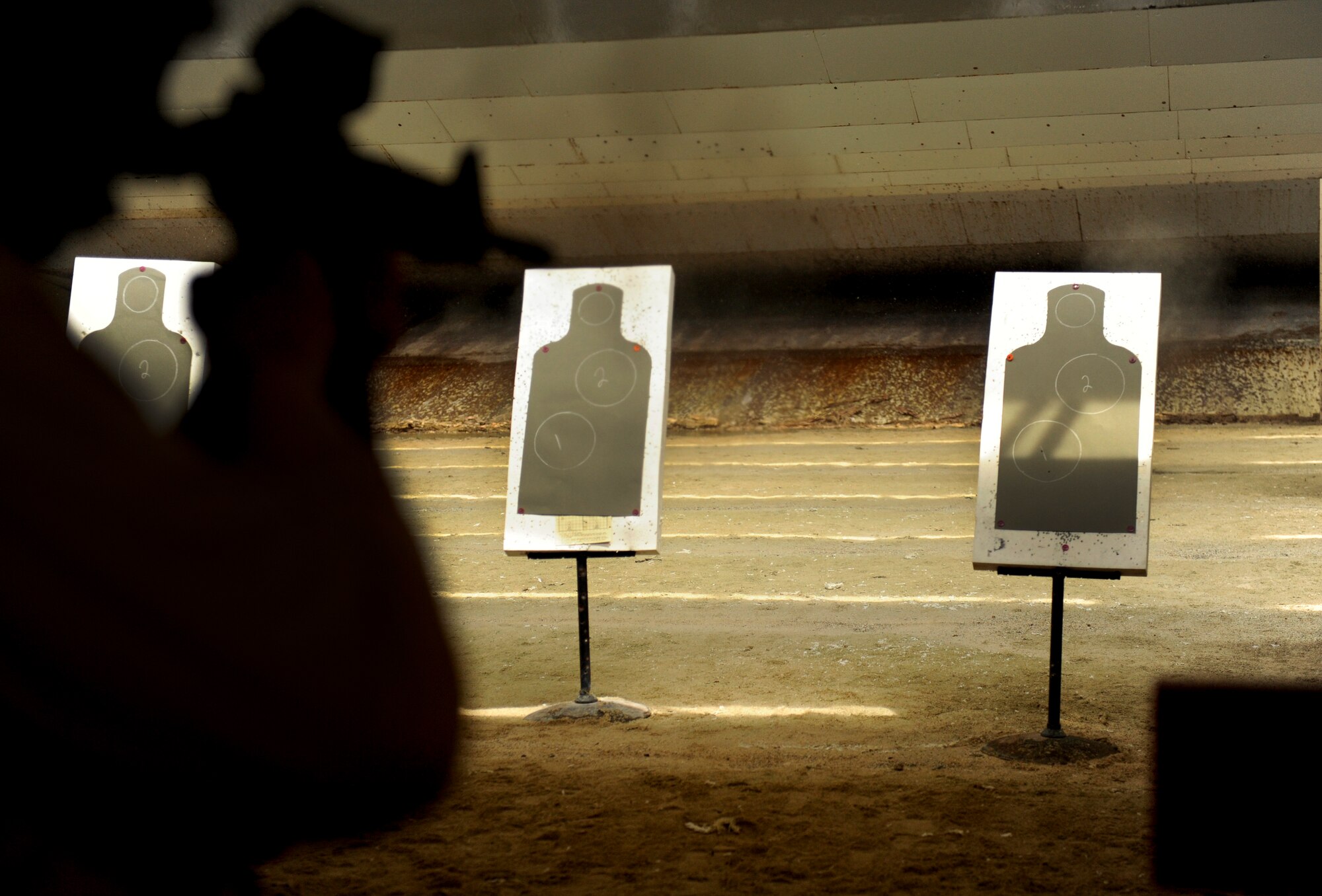A U.S. Air Force Airman qualifying on the M-4 Carbine fires at a close-range target as part of the new pre-deployment weapons qualification course on Kadena Air Base, Japan, July 16, 2012. The new Combat Arms qualification course, which incorporates five more qualification portions than the old course, began in November 2011 on Kadena. Since its initiation, Kadena has doubled the average pass rate for students enduring the course. (U.S. Air Force photo/ Airman 1st Class Maeson L. Elleman)
