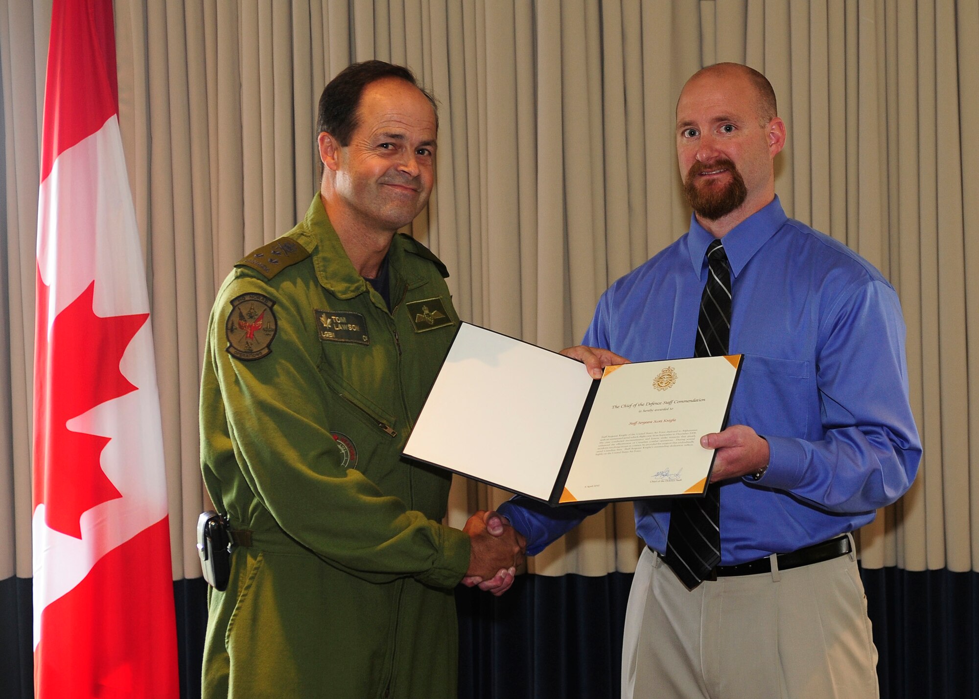 Lt. Gen.Tom Lawson, North American Aerospace Defense Command deputy commander, awarded Scott Knight, a former senior mission intelligence coordinator at the 42nd Attack Squadron at Creech Air Force Base, Nev., the Chief of Defense Staff Commendation medal on behalf of Gen. Walter Natynczyk, Chief of Defense Staff of the Canadian forces, July 18 at the Pacific Coast Club here, for actions that resulted in saving Canadian lives during a deployment to Kandahar, Afghanistan in 2008. (U.S. Air Force Photo/Michael Peterson)