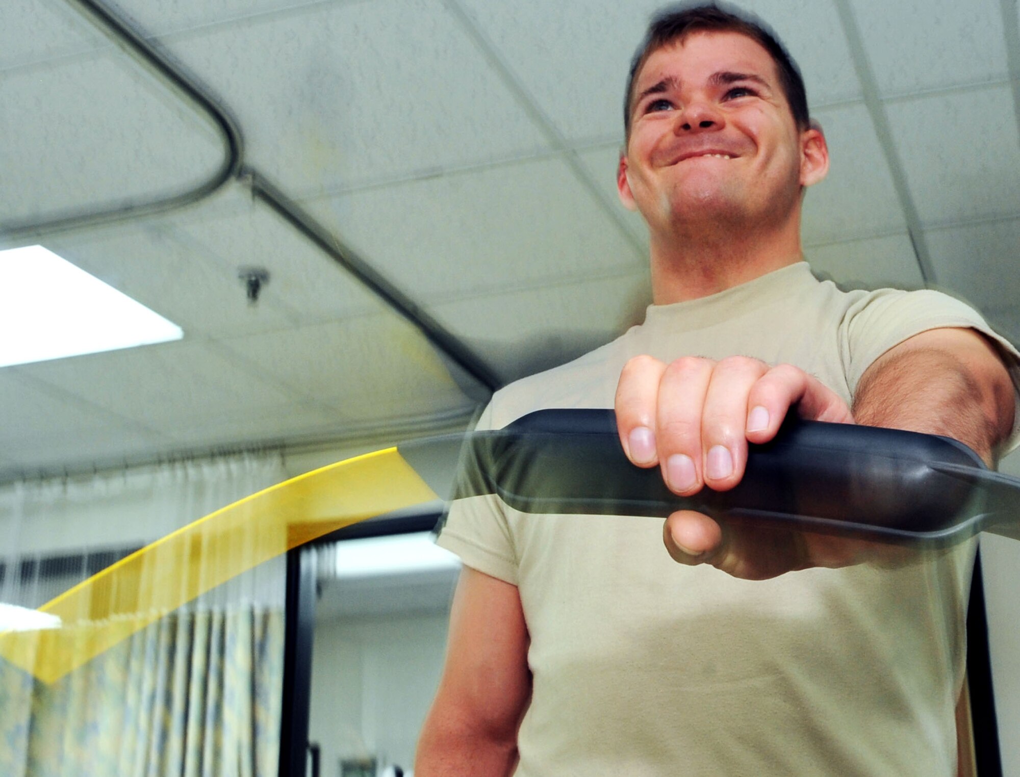 Senior Airman Marshall Hunsaker struggles with the body blade at the 51st Medical Operations Squadron Physical Therapy clinic, July 19, 2012. Hunsaker is repairing from a left shoulder surgery and will continue with various rehab activities to regain his strength and range of motion. Hunsaker is a 51st Fighter Wing Public Affairs broadcaster. (U.S. Air Force photo/Staff Sgt. Stefanie Torres)