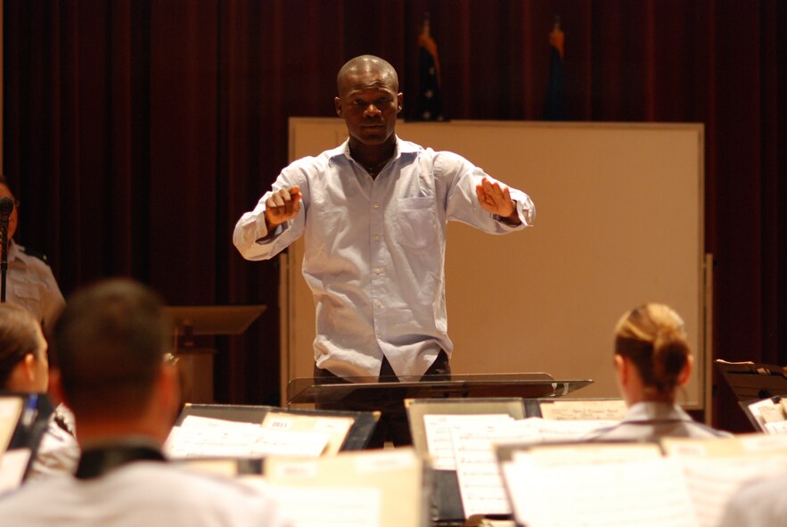 Capt. Abiodoun Patrick Odjo, international guest conductor, rehearses with the U.S. Air Force Band's Concert Band in preparation for their July 20, 23 and 24 performances. (U.S. Air Force photo by Master Sgt. Bob Kamholz) 
