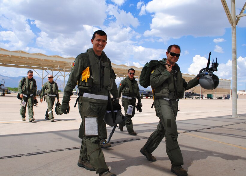Colombia air force pilots return from flying a sortie in their Kfir fighter aircraft at Davis-Monthan AFB, Ariz., during their preparation to perform in Red Flag. The 571st Mobility Support Advisory Squadron has been working with the Columbian air force to strengthen their partnership. (U.S. Air Force photo/Staff Sgt. John Ayre) 


