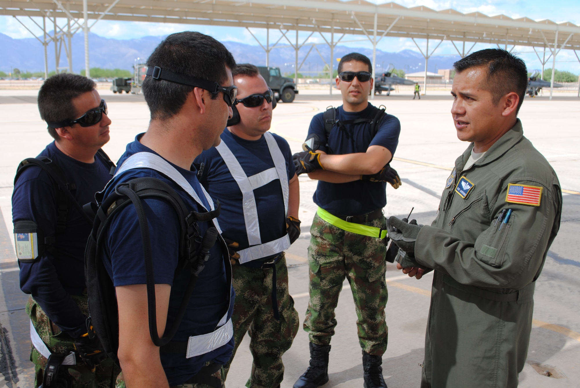 Staff Sgt. Javier Borges, 571st Mobility Support Advisory Squadron air advisor loadmaster, discuss proper palletizing procedures with members of the Colombian air force for their participation in Red Flag (U.S. Air Force photo by Staff Sgt. John Ayre)