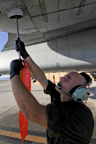 U.S. Air Force Staff Sgt. Nicholas Nelson, a crew chief with the 23d Aircraft Maintenance Squadron, 74th Aircraft Maintenance Unit, uses a fuel catcher to drain any residual fuel from the lines of an an A-10C Thunderbolt II at Nellis Air Force Base, Nev., July 16, 2012, during exercise Red Flag 12-4.  Fourteen A-10s are deployed to Nellis from Moody Air Force Base, Ga., along with more than 200 aircrew, maintainers and support personnel.  (U.S. Air Force photo by Master Sgt. Sonny Cohrs/Released)   