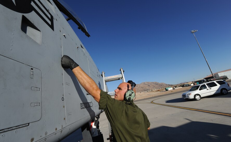 U.S. Air Force Staff Sgt. Nicholas Nelson, a crew chief with the 23d Aircraft Maintenance Squadron, 74th Aircraft Maintenance Unit, performs post-flight inspections on an an A-10C Thunderbolt II at Nellis Air Force Base, Nev., July 16, 2012, during exercise Red Flag 12-4.  Fourteen A-10s are deployed to Nellis from Moody Air Force Base, Ga., along with more than 200 aircrew, maintainers and support personnel.  (U.S. Air Force photo by Master Sgt. Sonny Cohrs/Released)   