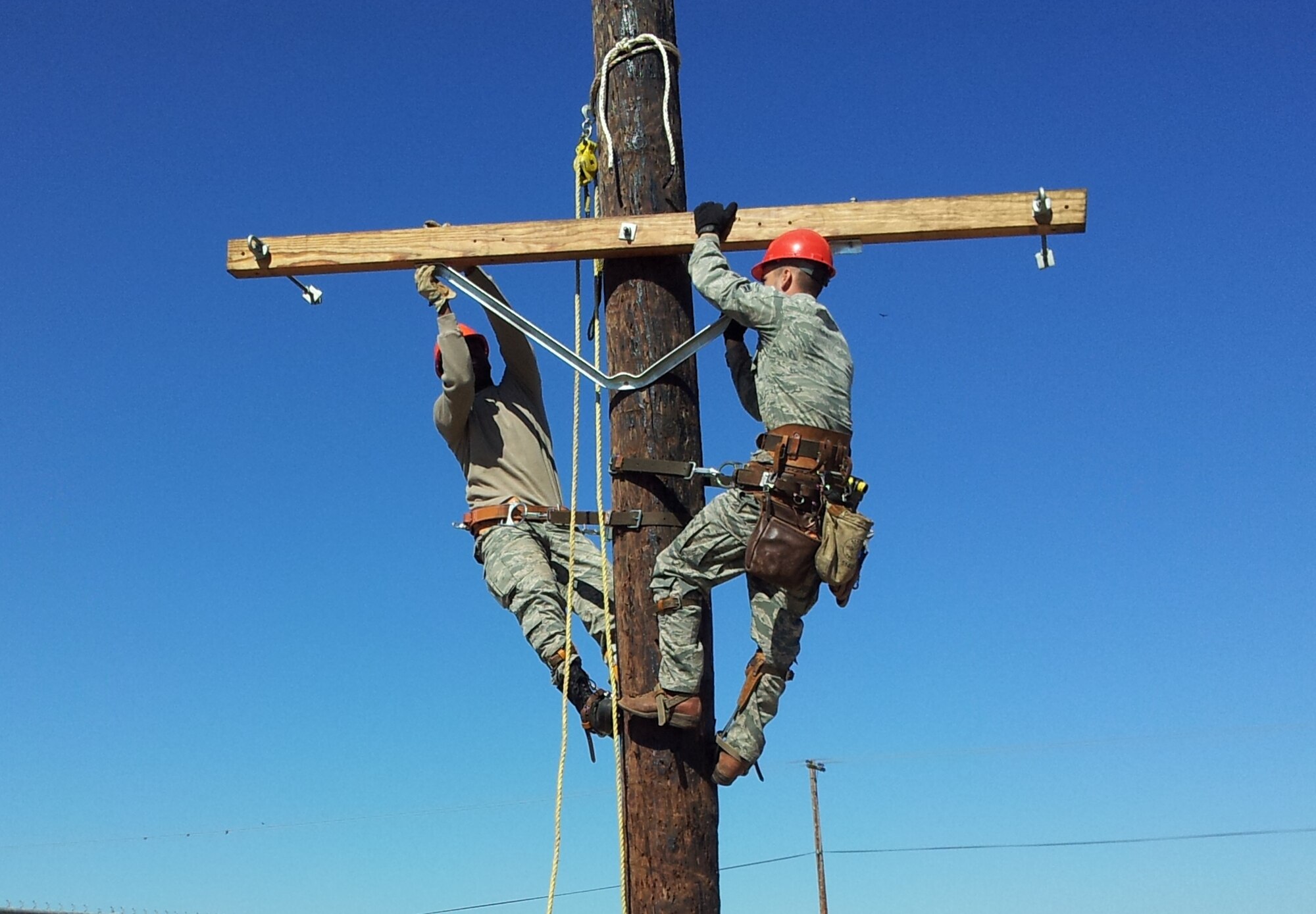 City Light and Power and Civil Engineer linemen increase the gap between each phase of the 12,000 volt primary lines July 18 and 19 at the Travis Duck Pond. This project aims to reduce nuisance power outages caused by large birds. (Courtesy photo)
