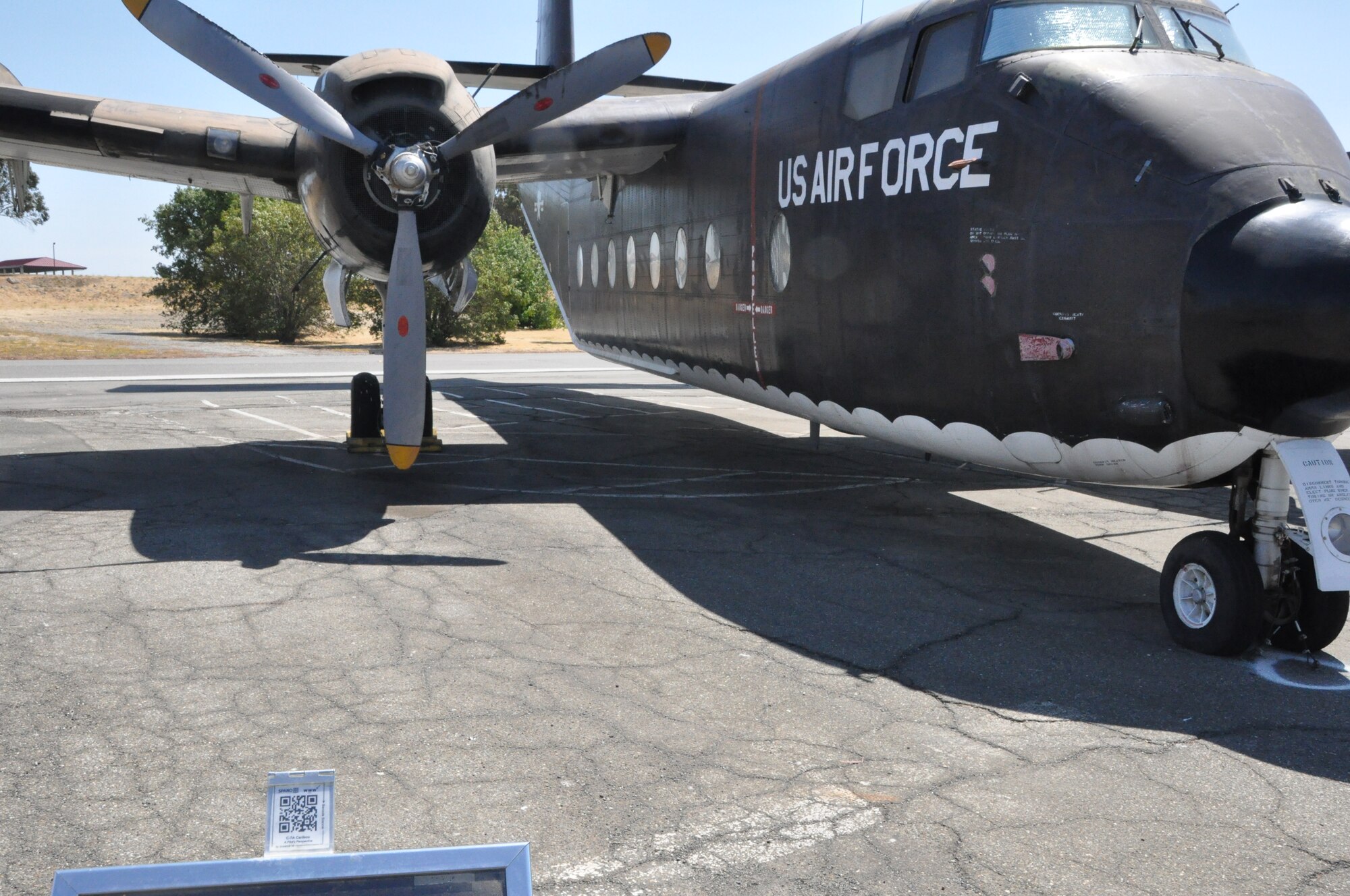 A quick-response code is seen Ju;y 16 atop the display at the Jimmy Doolittle Air and Space Museum for the C-7 Caribou. The museum has installed approximately 50 of the codes to improve the experience of visiting the facility for guests. (U.S. Air Force photo/Nick DeCicco)