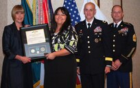 Kimberly Ross is awarded the Commander's Award for Civilian Service from Dr. Carol Lowman during an awards ceremony May 16 at Redstone Arsenal, Ala., after being named the Army Contracting Command's Outstanding Intern of the Year for 2011. Lowman is the deputy to the commanding general at ACC. Also pictured are Brig. Gen. Kirk Vollmecke, the Mission and Installation Contracting Command commanding general, and ACC Command Sgt. Maj. John Murray.  (Photo by Larry McCaskill)