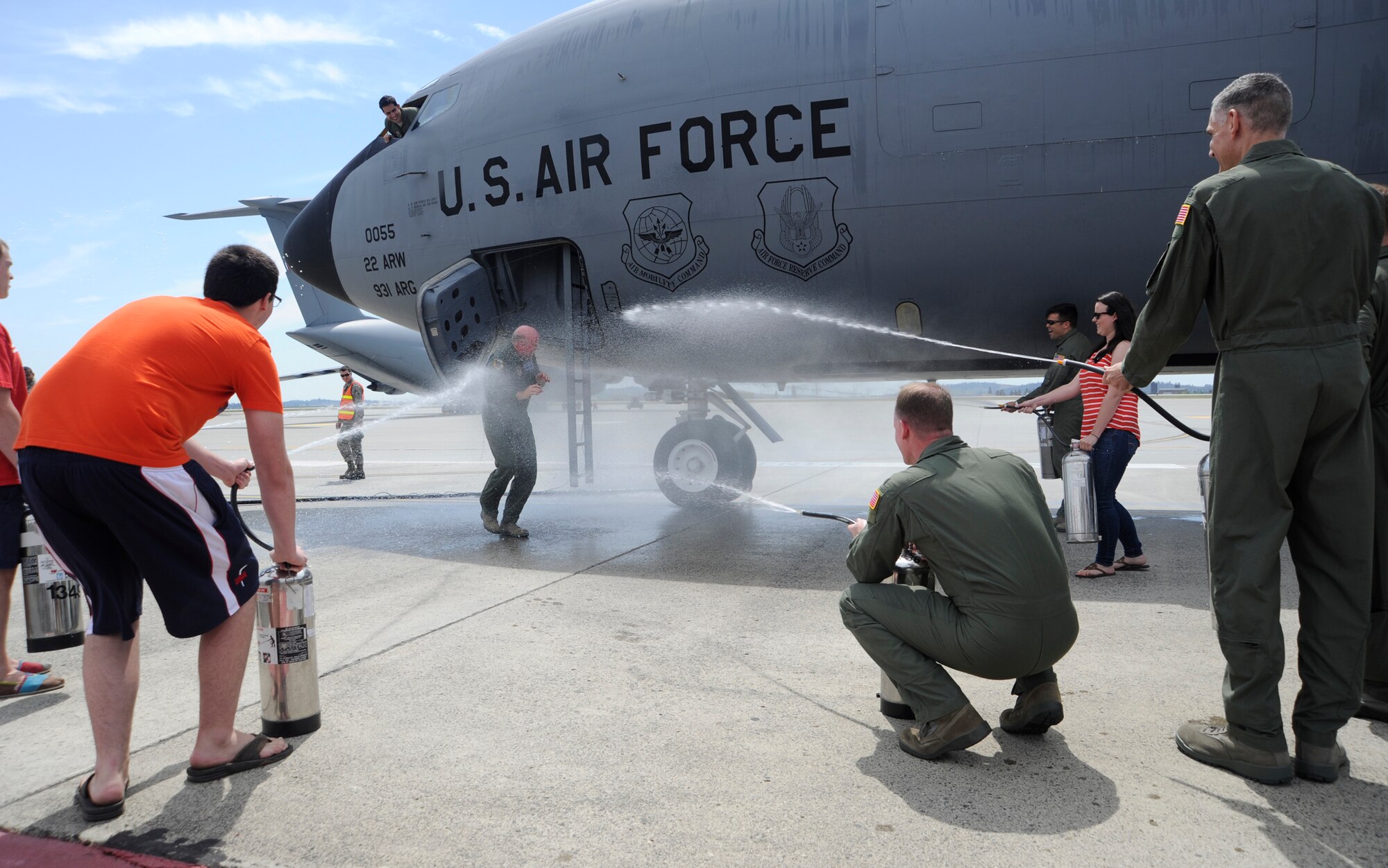Col. Paul Guemmer, 92nd Air Refueling Wing commander, is hosed down with water by members of Team Fairchild, familiy and friends upon completion of his final flight at Fairchild Air Force Base, Wash., July 17, 2012. The final flight is an aviation tradition in which aircrew members, upon completion of their last flight with the wing, or "fini flight," are met and hosed down with water by their unit comrades, family and friends. (U.S. Air Force photo by Airman 1st Class Ryan Zeski)