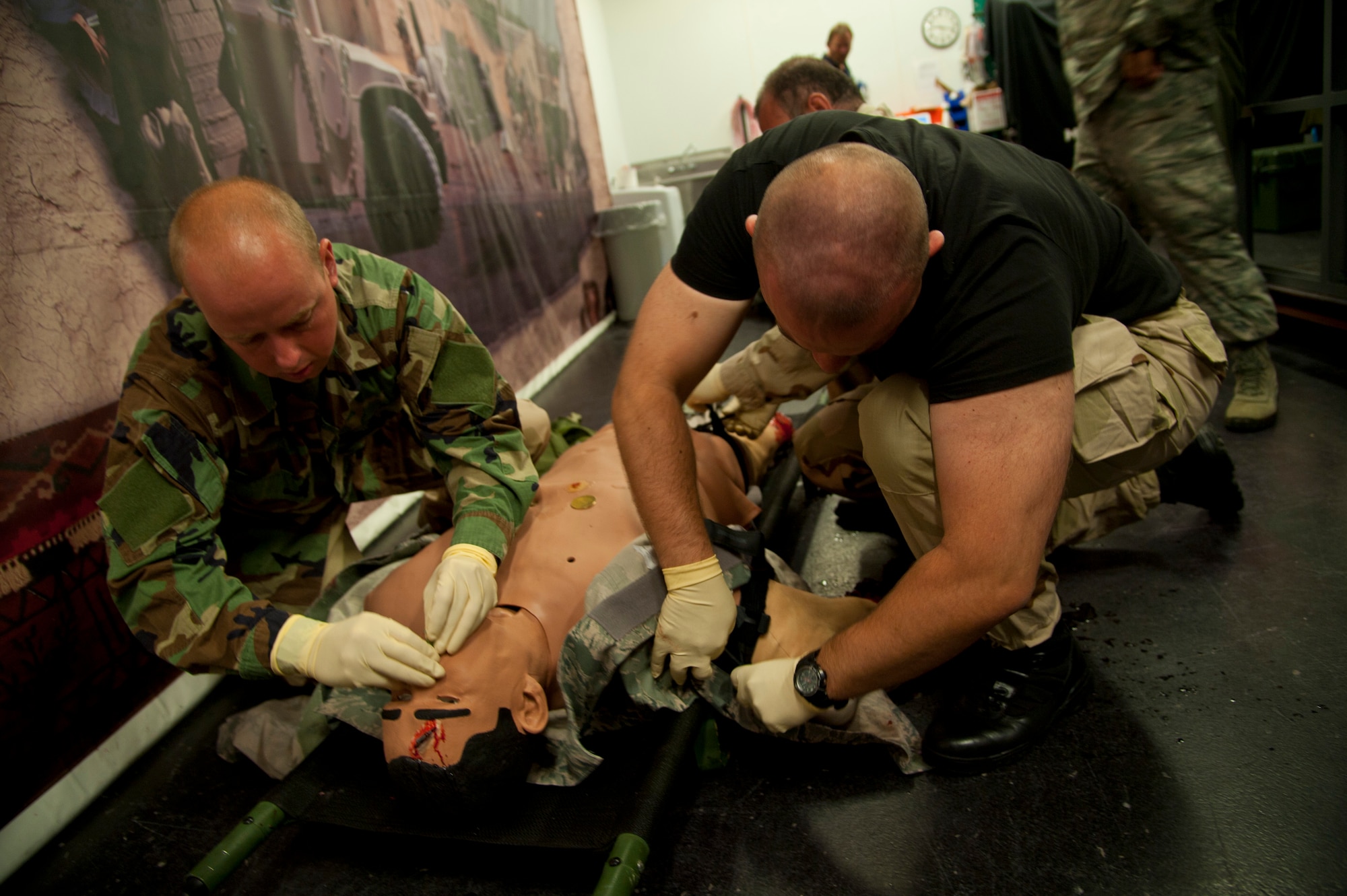 Polish service members insert a nasopharyngeal tube into a medical training mannequin at the Tactical Operations Medical Skills Lab on Hurlburt Field, Fla., July 6, 2012. The Polish service members, with the assistance of Airmen participating in the Language Enabled Airman Program, took part in emergency medical training in a simulated-combat environment. (U.S. Air Force photo/ Staff Sgt. John Bainter) (Released)