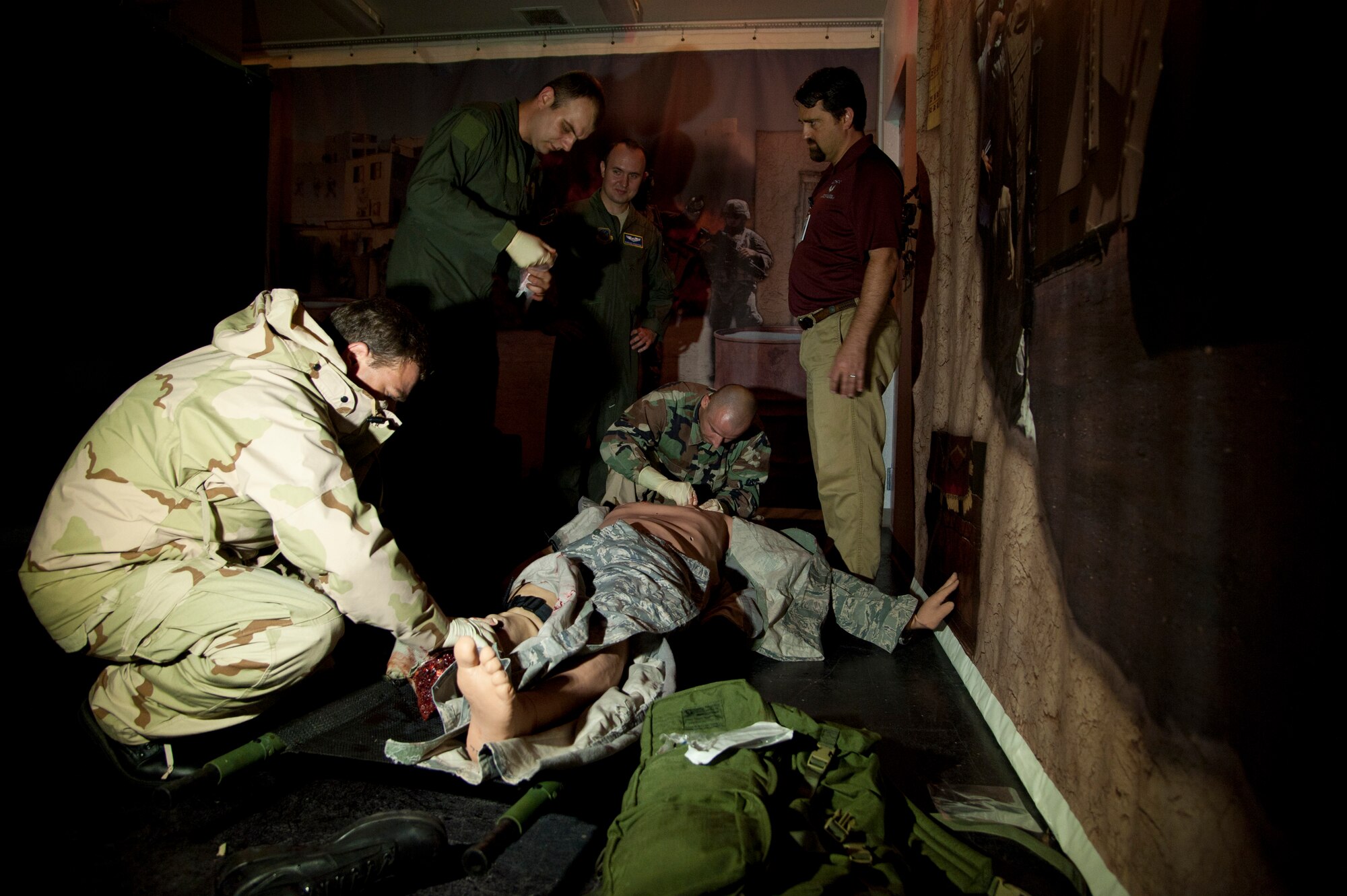 Polish service members check for a clear airway and treat a leg wound on a medical training mannequin at the Tactical Operations Medical Skills Lab on Hurlburt Field, Fla., July 6, 2012. The Polish service members use translators employed by the Language Enabled Airman Program to communicate with the course trainers and other Team Hurlburt members. (U.S. Air Force photo/ Staff Sgt. John Bainter) (Released)