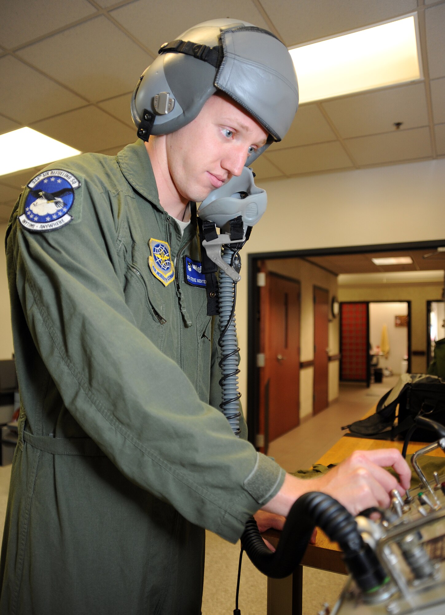 Senior Airman Steven Mertens, 344th Air Refueling Squadron boom operator, prepares to preflight check his helmet July 19, 2012, McConnell Air Force Base, Kan. As a boom operator, Mertens inspects, operates and troubleshoots in-flight refueling systems. (U.S. Air Force photo/Airman 1st Class Jose L. Leon)
