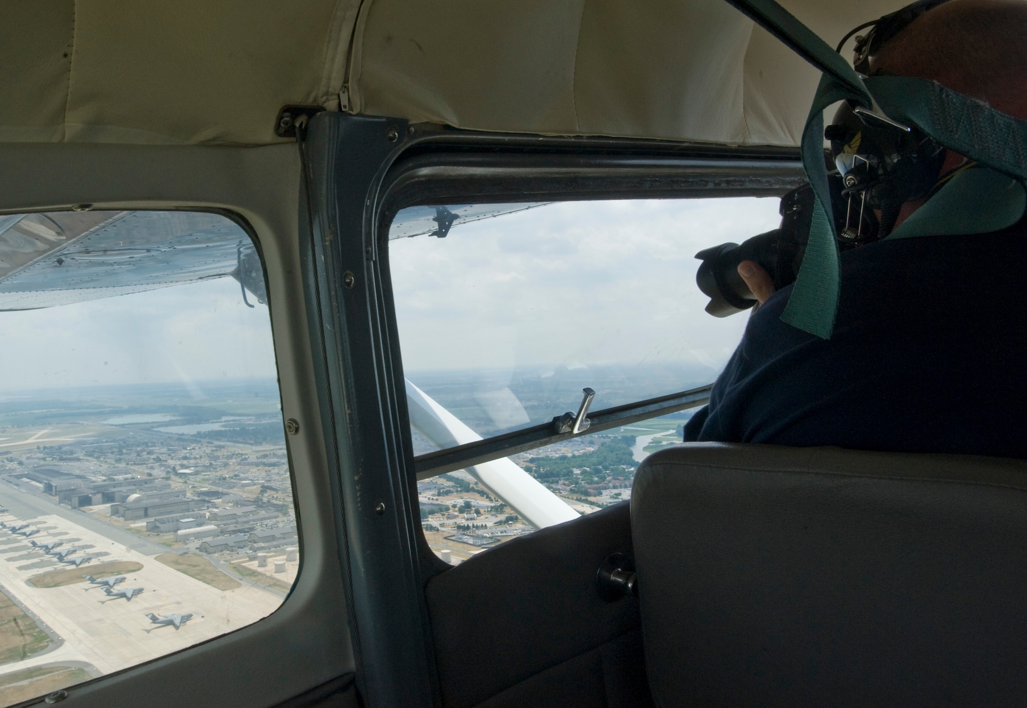 Clive Bennett of Aviation News Magazine takes photographs of Dover Air Force Base, Del., while inside a plane flown by a member of the Aero Club July 16, 2012. (U.S. Air Force photo by Senior Airman Jacob Morgan) 