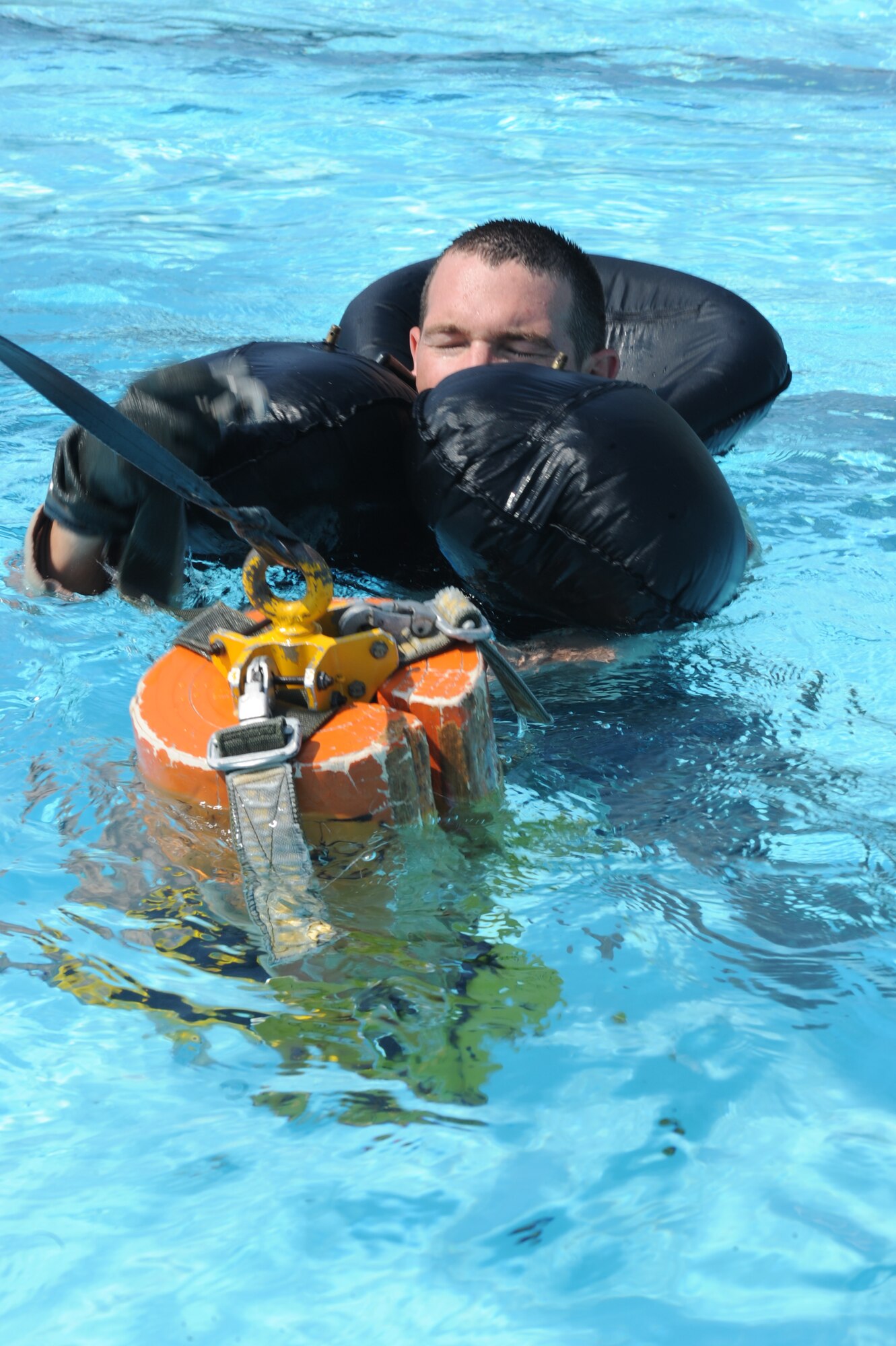 U.S. Air Force Capt. Jack Rose, 334th Fighter Squadron weapon systems operator, attempts to hook himself around a force penetrator during a survival, evasion, resistance and escape water survival course at Seymour Johnson Air Force Base, N.C., July 18, 2012. (U.S. Air Force photo/Airman 1st Class John Nieves Camacho/Released)