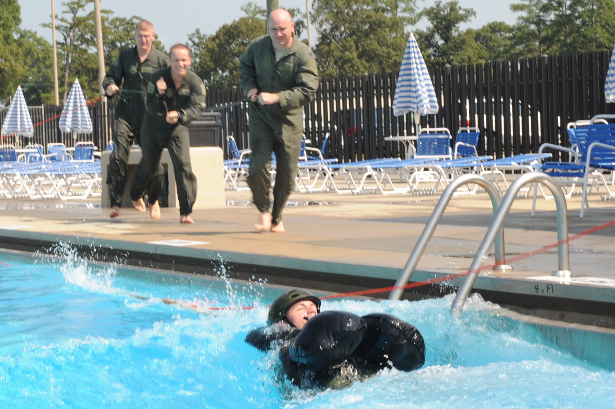 Aircrew members perform a parachute drag exercise during a survival, evasion, resistance and escape water survival course at Seymour Johnson Air Force Base, N.C., July 18, 2012. The exercise simulated high winds blowing an ejected aircrew member after a water landing. (U.S. Air Force photo/Airman 1st Class John Nieves Camacho/Released)